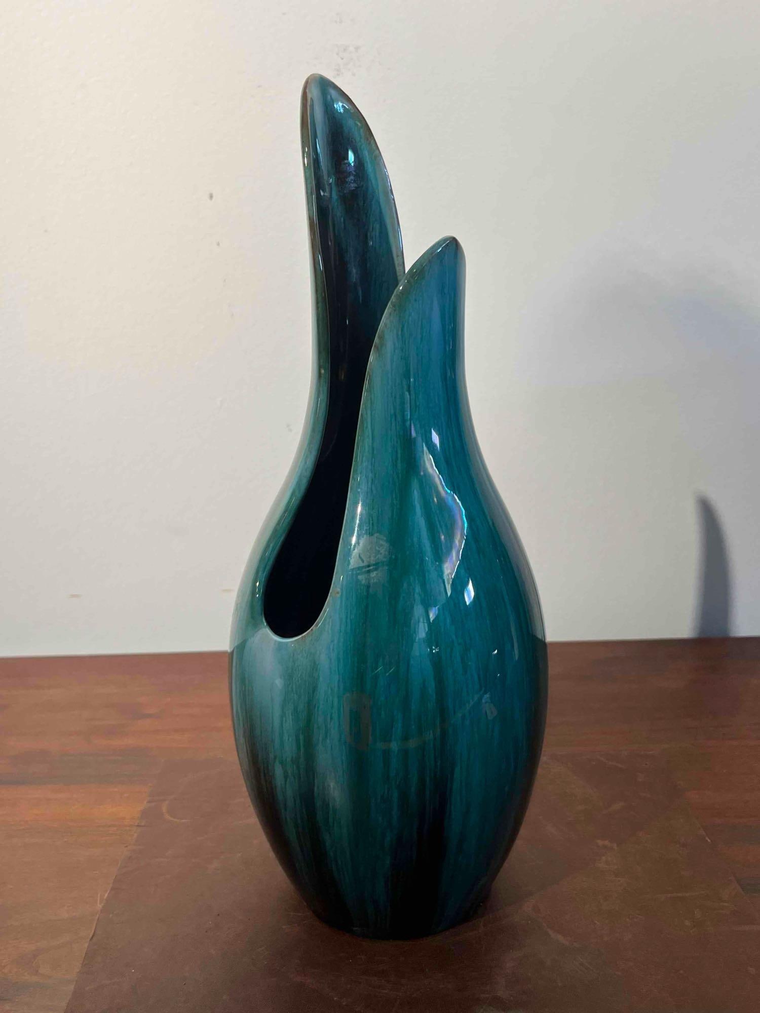 Blue Mountain Pottery Glazed Spire Vase: A Canadian glazed red earthenware spire vase featuring a bulbous, teardrop-shaped body that tapers into an asymmetrical split neck. One side of the neck reaches a sharp point, while a deep cleft creat