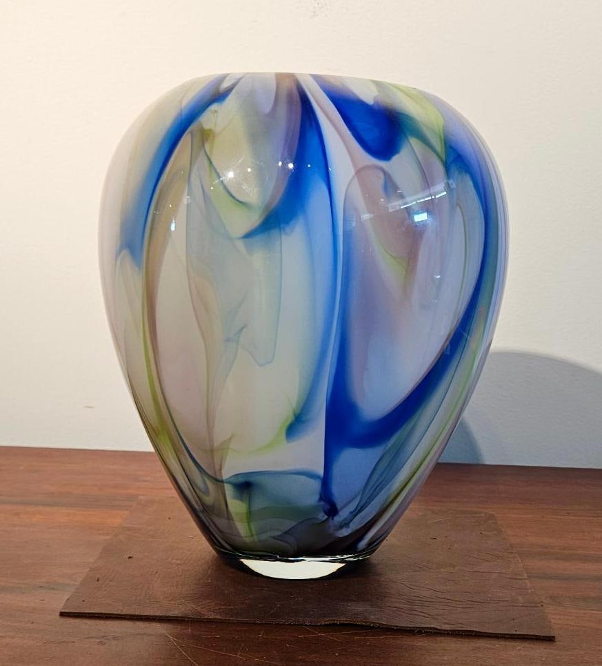 Hand Blown Cased Art Glass Swirl Vase: A large hand-blown art glass vase of ovoid form tapering to a narrow circular rim. The vessel is constructed of cased glass, featuring an internal layer of translucent white glass decorated with vibra