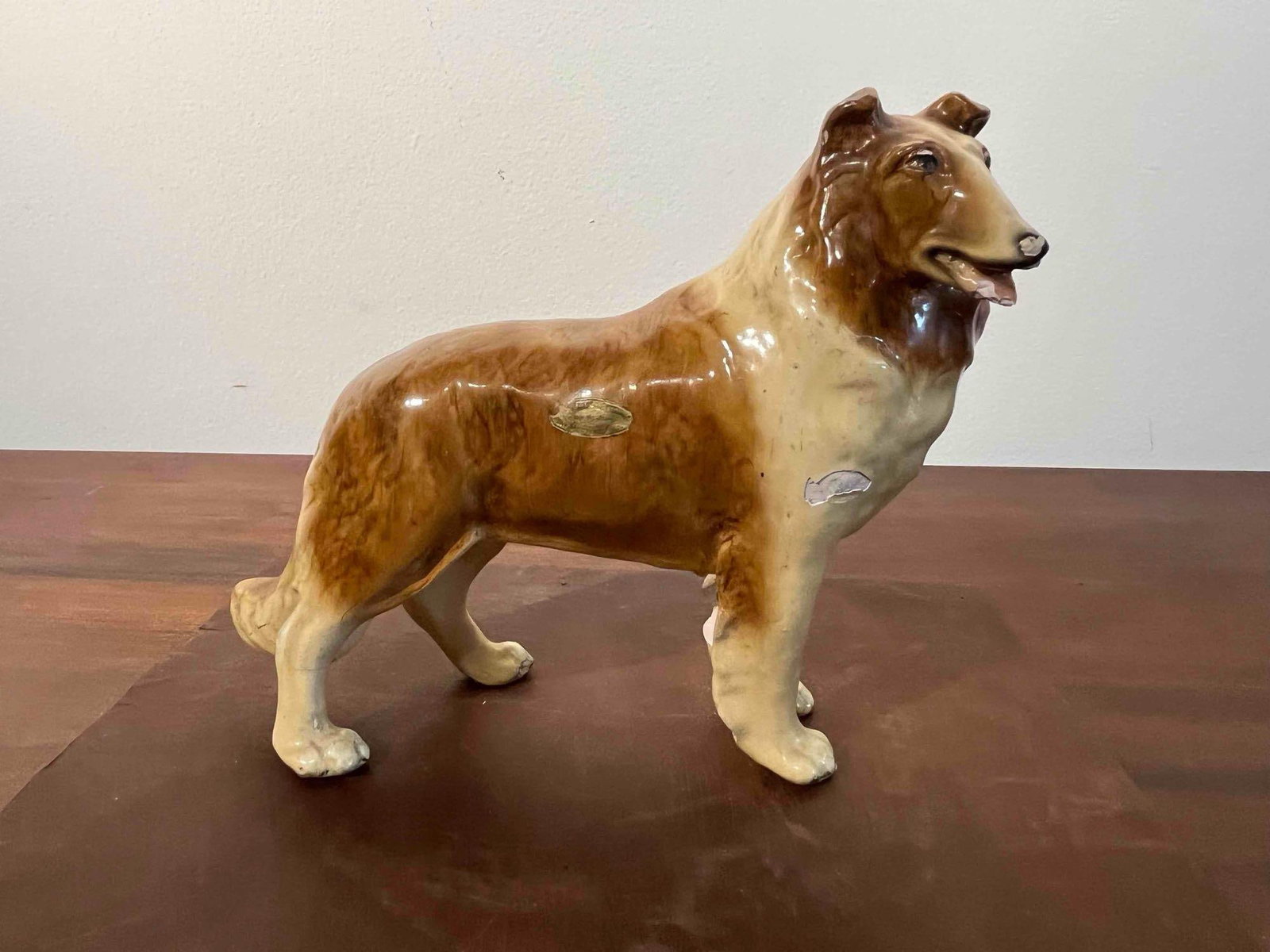 Mortens Studio Rough Collie Figurine: A mid-century composition figurine of a Rough Collie dog manufactured by Mortens Studio. The dog is modeled in a standing, alert posture with its head turned to the right and its mouth slightly open. 