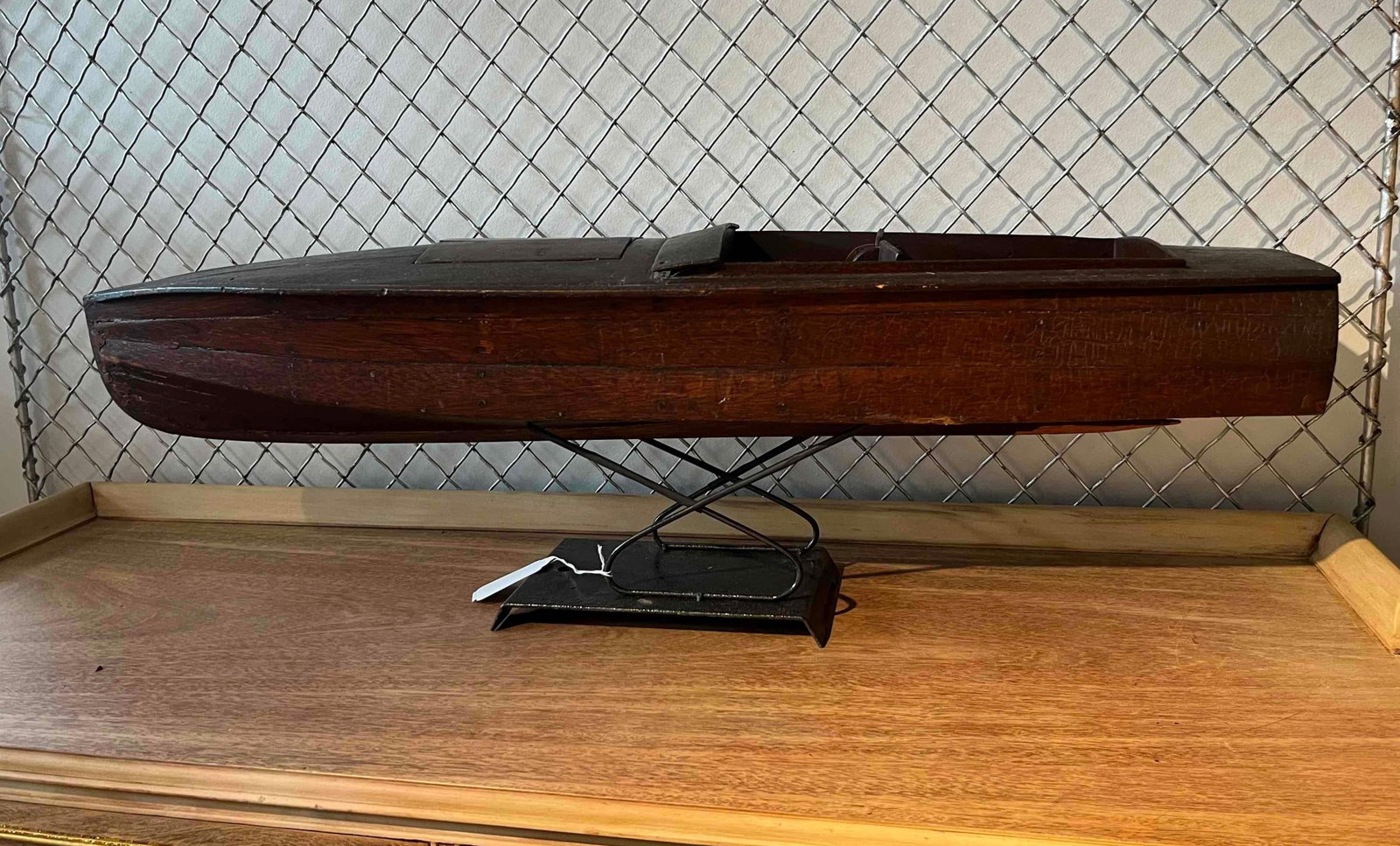 Planked Wood Speed Launch Pond Boat: This model boat is an early 20th-century speed launch or pond boat. The hull is of planked construction, featuring individual wooden strips secured with small metal pins or tacks to create a narrow