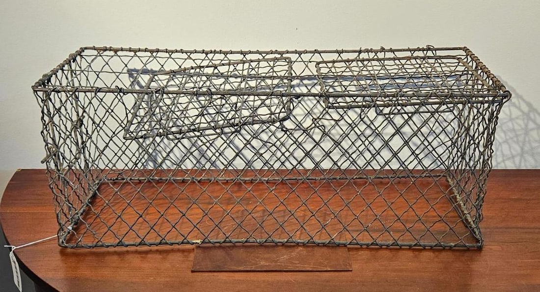 Industrial Wrought Iron Wire Basket: This large rectangular transport basket or cage is constructed from heavy-gauge wrought iron or steel wire. The body of the container is enclosed in a hand-woven diamond-pattern wire mesh, while the