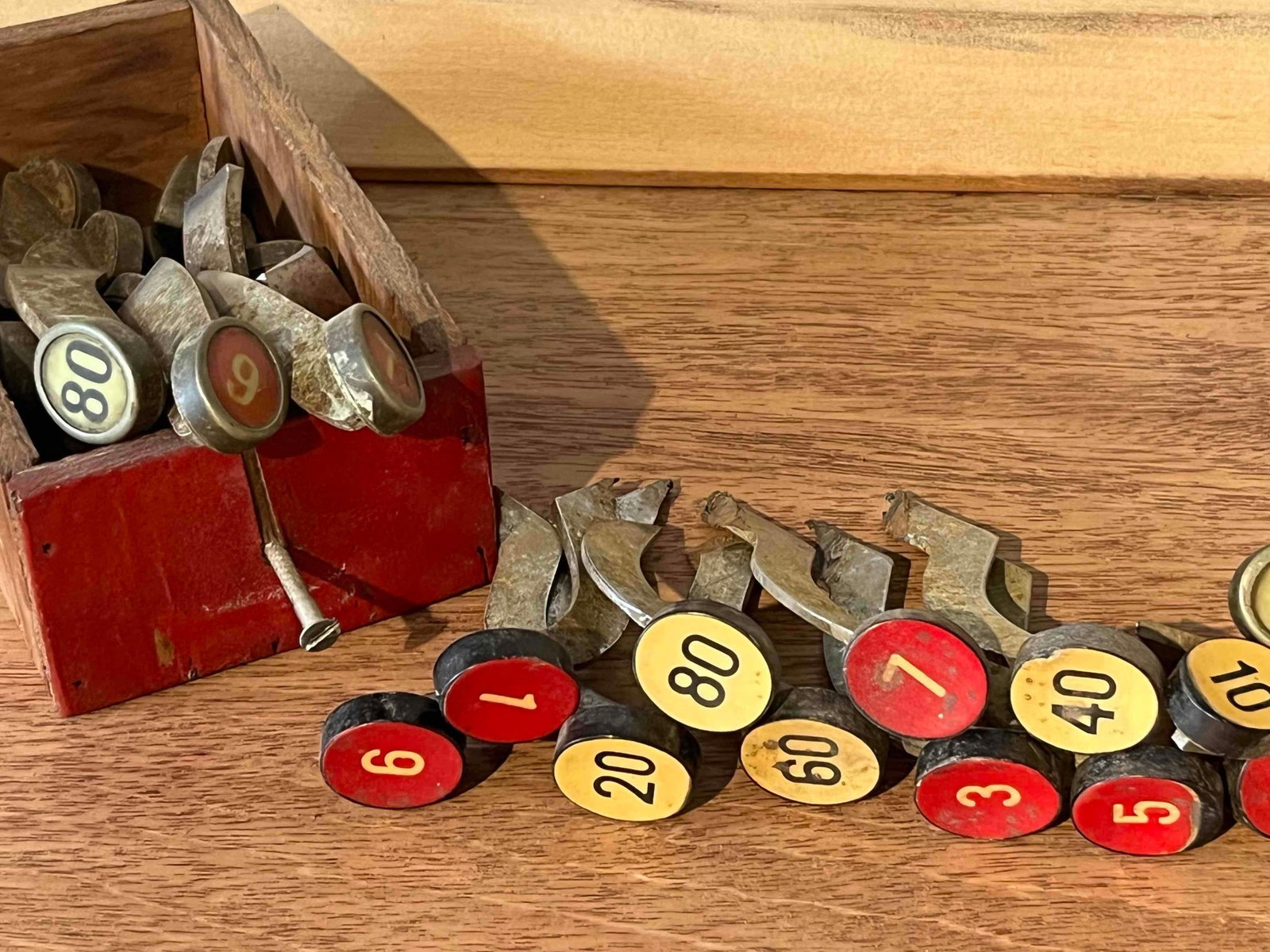 Cash Register Indicator Flags: This lot comprises a collection of cash register indicator flags, also known as price tabs or arms, commonly used in mechanical point-of-sale machines. Each component consists of a curved cast metal