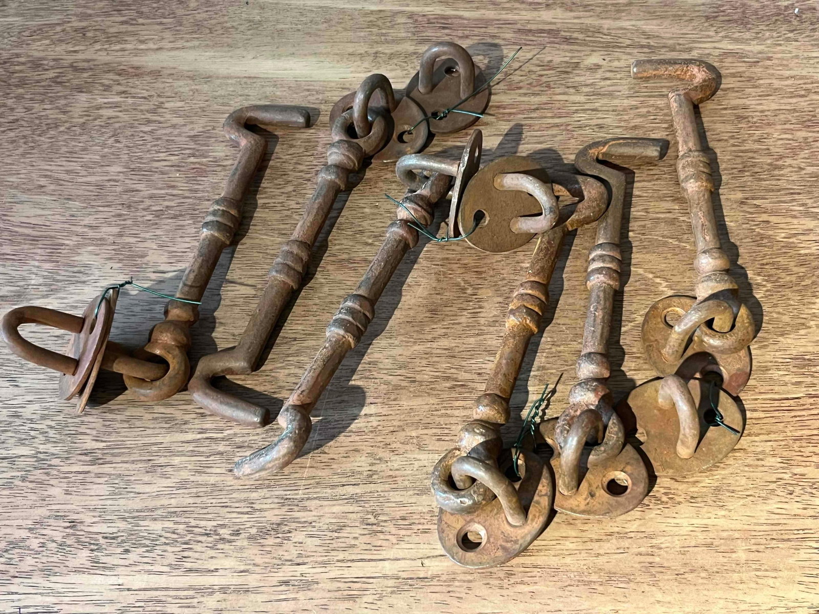 Set 6 Iron Cabin Hook & Eye Latches: A set of six matching architectural cabin hook and eye latches, suitable for gates, doors, or shutters. The latches are constructed from heavy iron with a rustic industrial finish. Each assembly