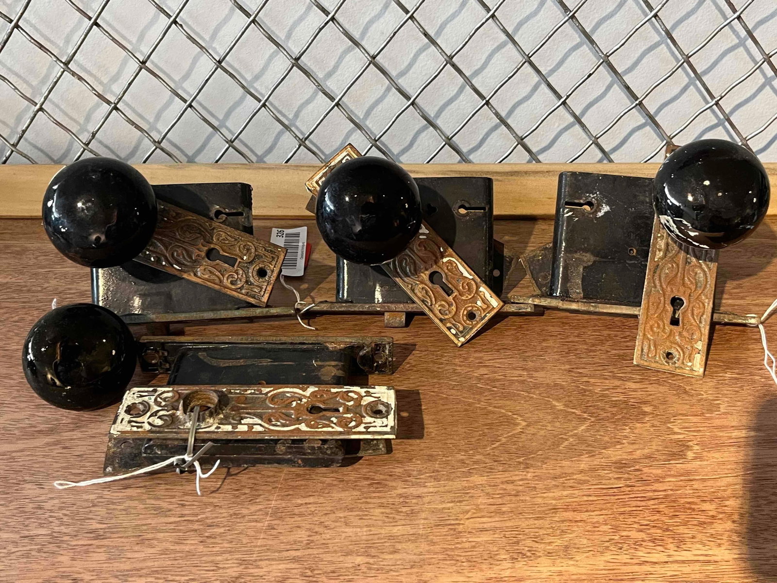 Victorian Iron & Porc. Mortise Lock Set: This set of architectural salvage comprises a collection of late 19th-century Victorian interior door hardware. The lot includes several rectangular mortise lock assemblies, each featuring a cast iron