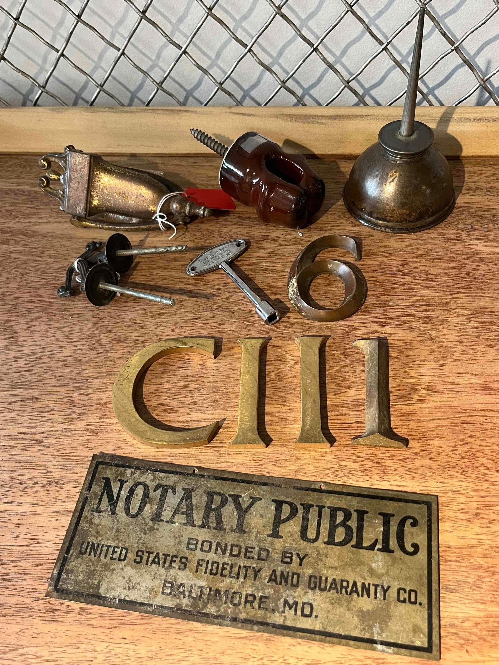Arch. Hardware, Tools & Notary Sign: An assortment of architectural hardware, industrial tools, and professional ephemera. The collection includes a rectangular metal advertising sign printed in black ink with a decorative border and