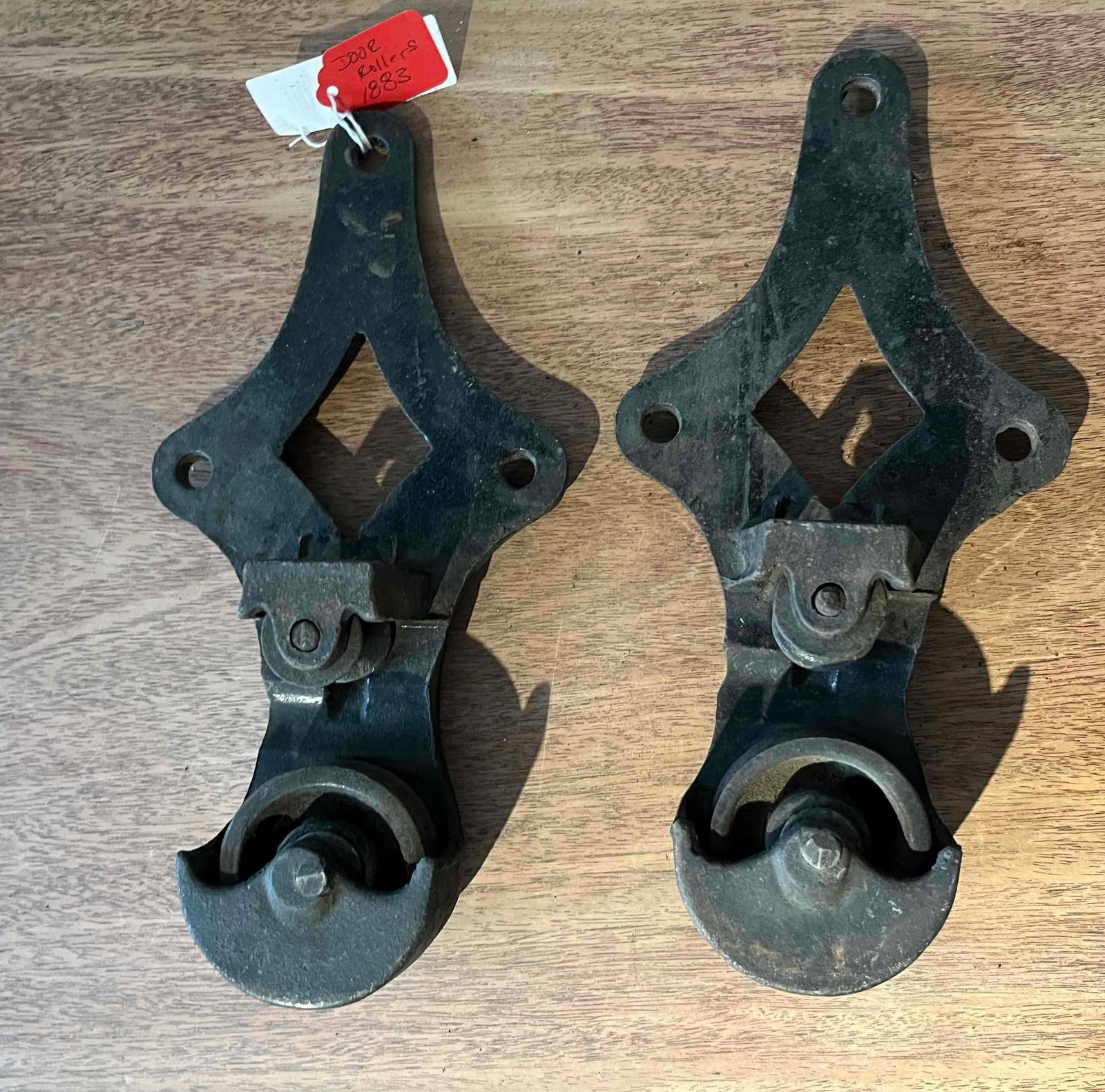 Pair Allith-Prouty Cast Iron Rollers: This matching pair of heavy-duty cast iron barn door hangers is the Reliable No. 2 model produced in the United States. Each hanger is designed with an open diamond-shaped mounting plate containing