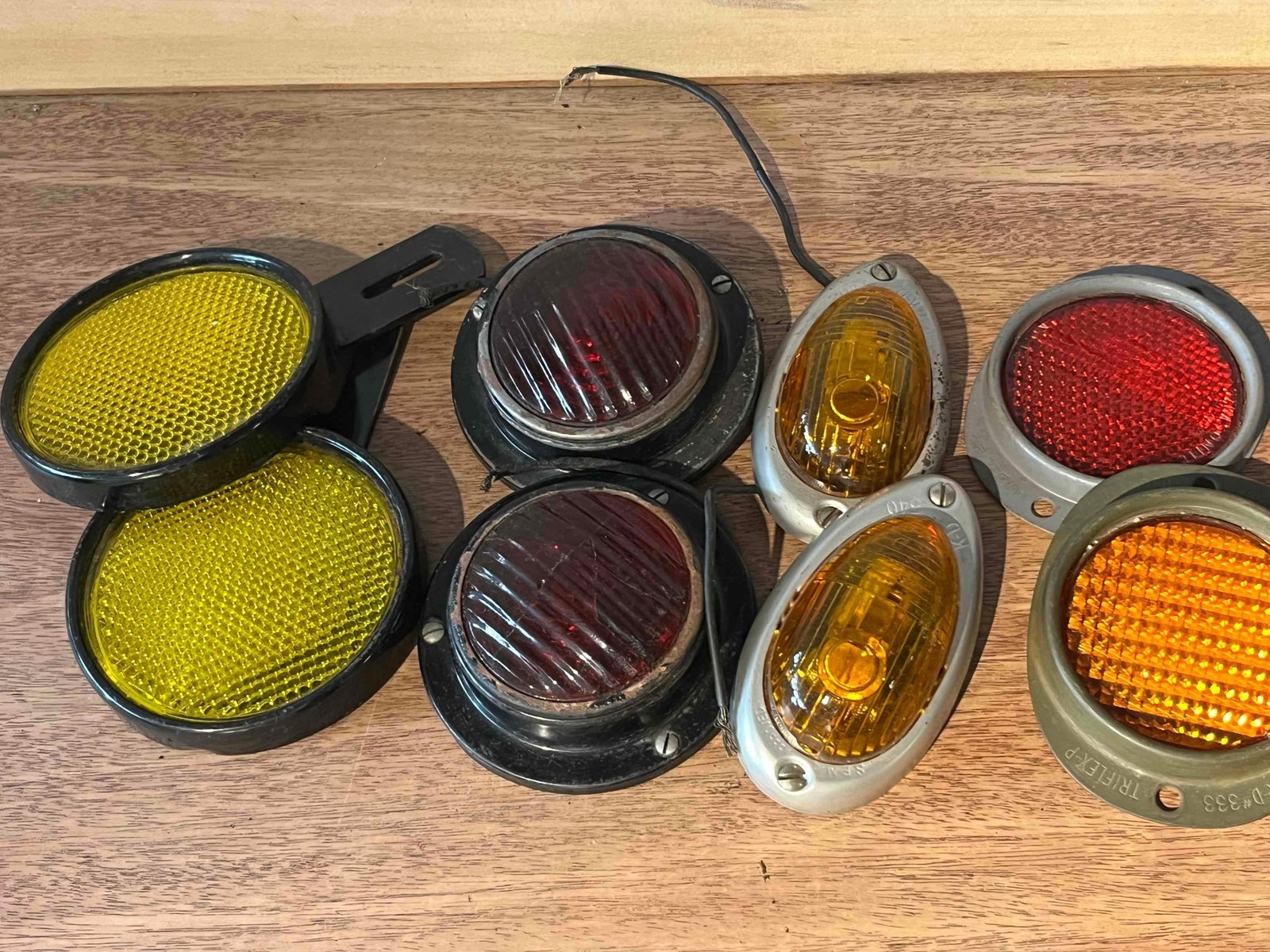 K-D Lamp Co. & Stimsonite Auto Lighting: An assortment of mid-20th-century automotive exterior lighting and safety reflectors, including components likely intended for commercial trucks or trailers. The collection features several units