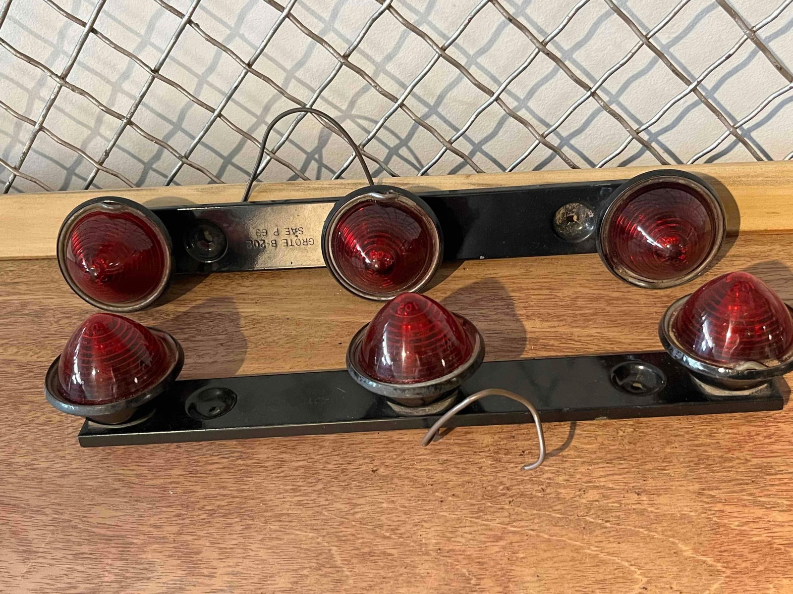 Pair Grote B-202 3-Light Marker ID Bars: A pair of mid-century American automotive marker light bars, manufactured by Grote. These identification bars are designed for commercial truck or trailer use and feature three red translucent