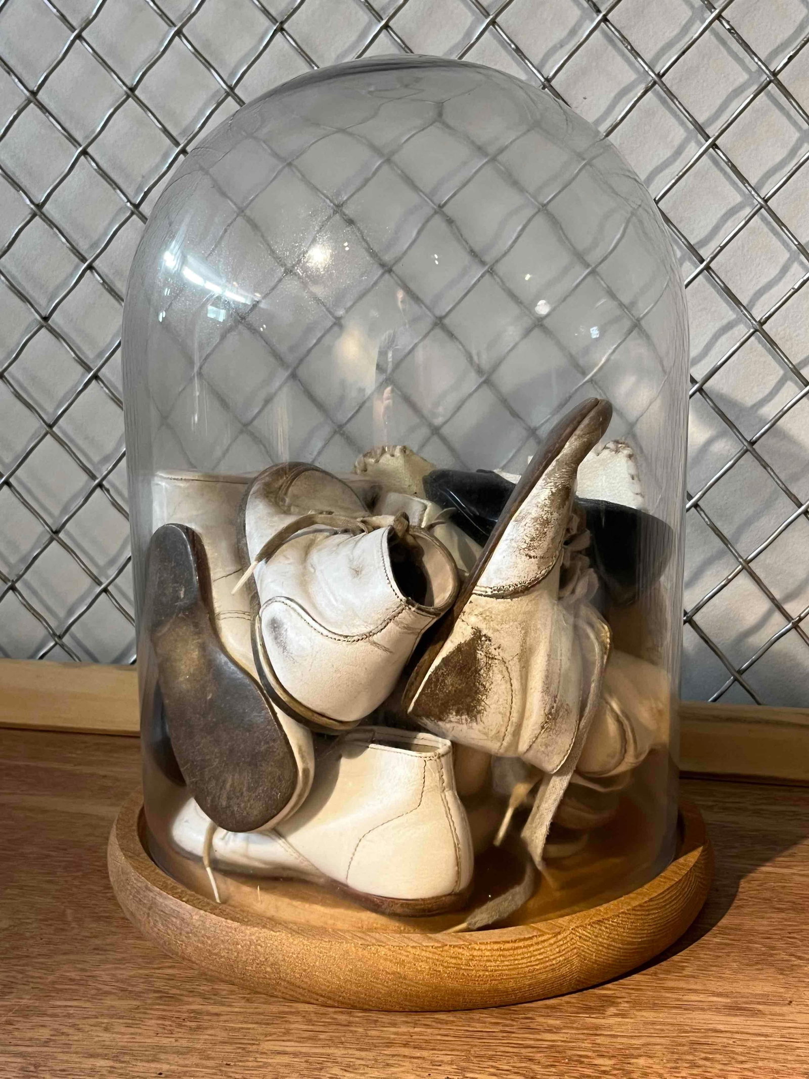 Child/Infant Footwear, Glass Cloche: An assortment of children's and infant shoes presented as a decorative display within a large glass dome. The collection features several styles of footwear, including white leather high-top lace-up b