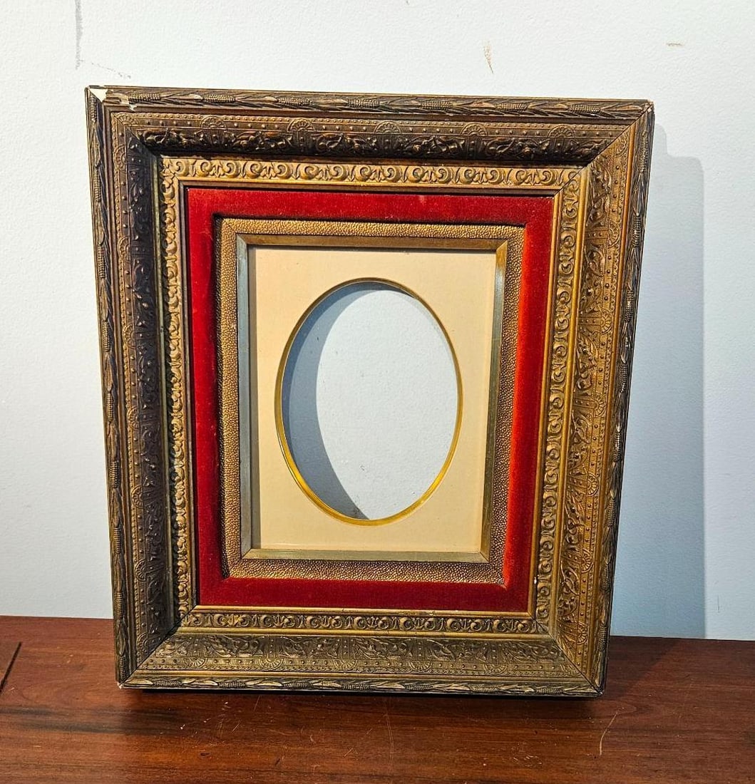 Gilt & Red Velvet Tiered Portrait Frame: An ornate, multi-layered portrait frame featuring a heavily molded and gilded composition-on-wood outer border decorated with scrolls and foliate motifs. The tiered interior construction incorporates 