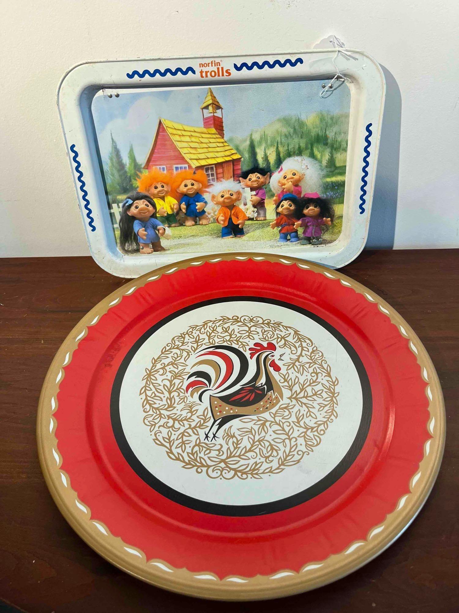 Pair 1992 Norfin Trolls Litho Tin Trays: This lot features two lithographed tin trays with distinct themes. The first is a rectangular folding lap tray featuring a full-color graphic of eight Norfin Trolls posed in front of a red and yellow 