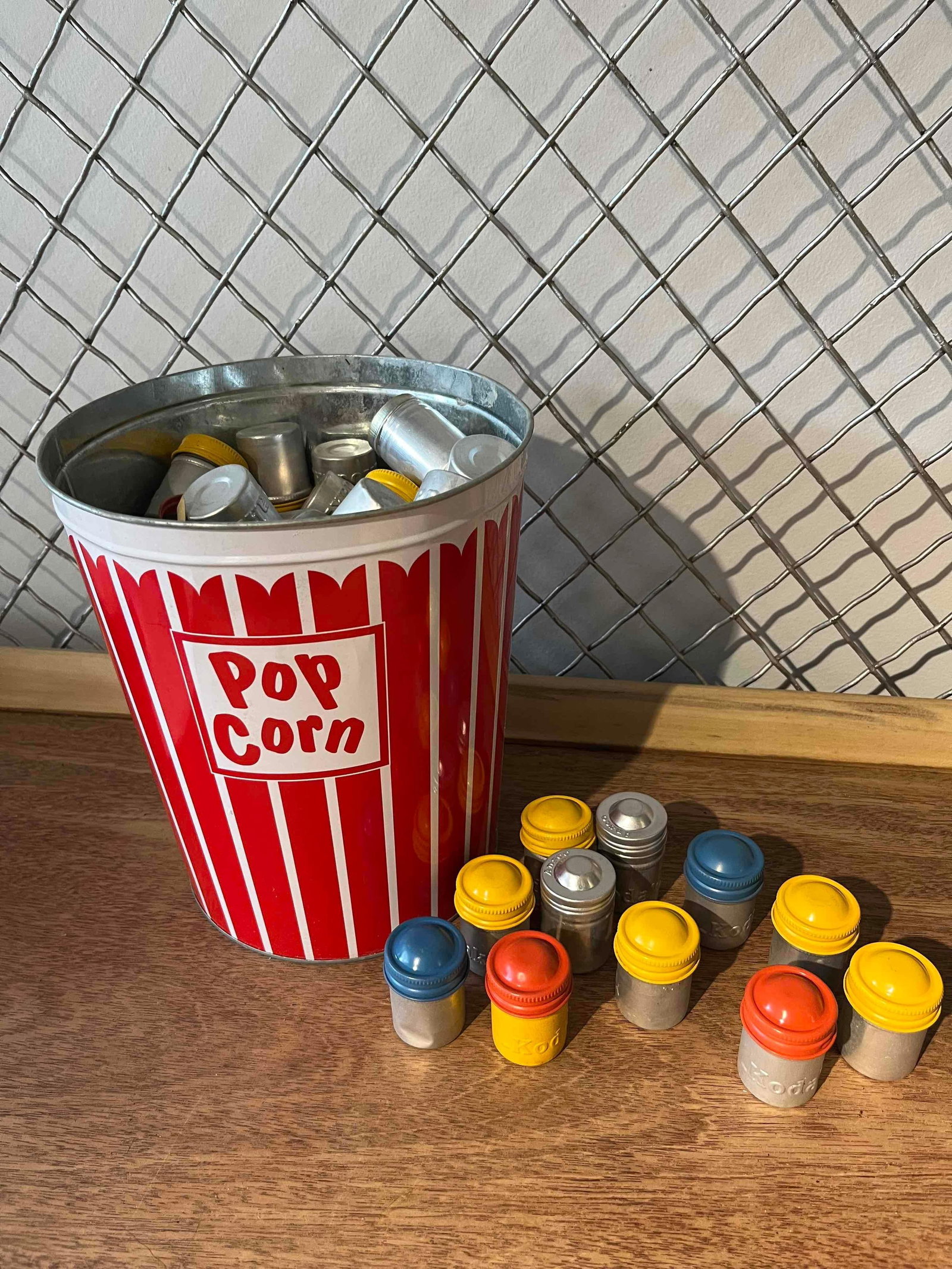 Kodak & Ansco 35mm Film Canisters & Tin: This lot comprises an assortment of approximately 60 to 80 metal film canisters manufactured by the Eastman Kodak Company and Ansco. Designed for 35mm film rolls, the canisters feature formed aluminum