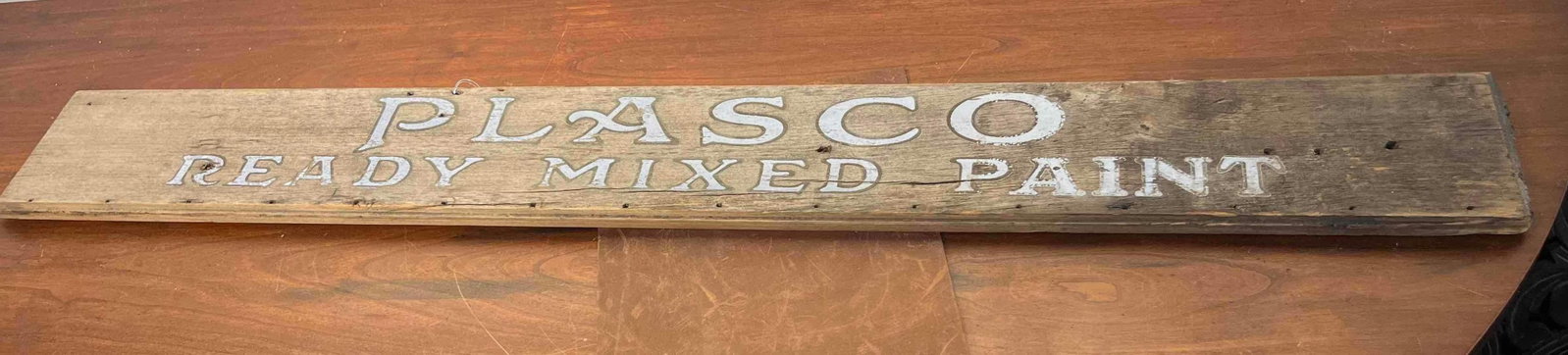 Plasco Paint Wooden Advertising Sign: A American advertising sign for Plasco Ready Mixed Paint, a brand produced by the Pittsburgh Plate Glass Company in the early to mid-20th century. The sign is made from a single rectangular plank of w