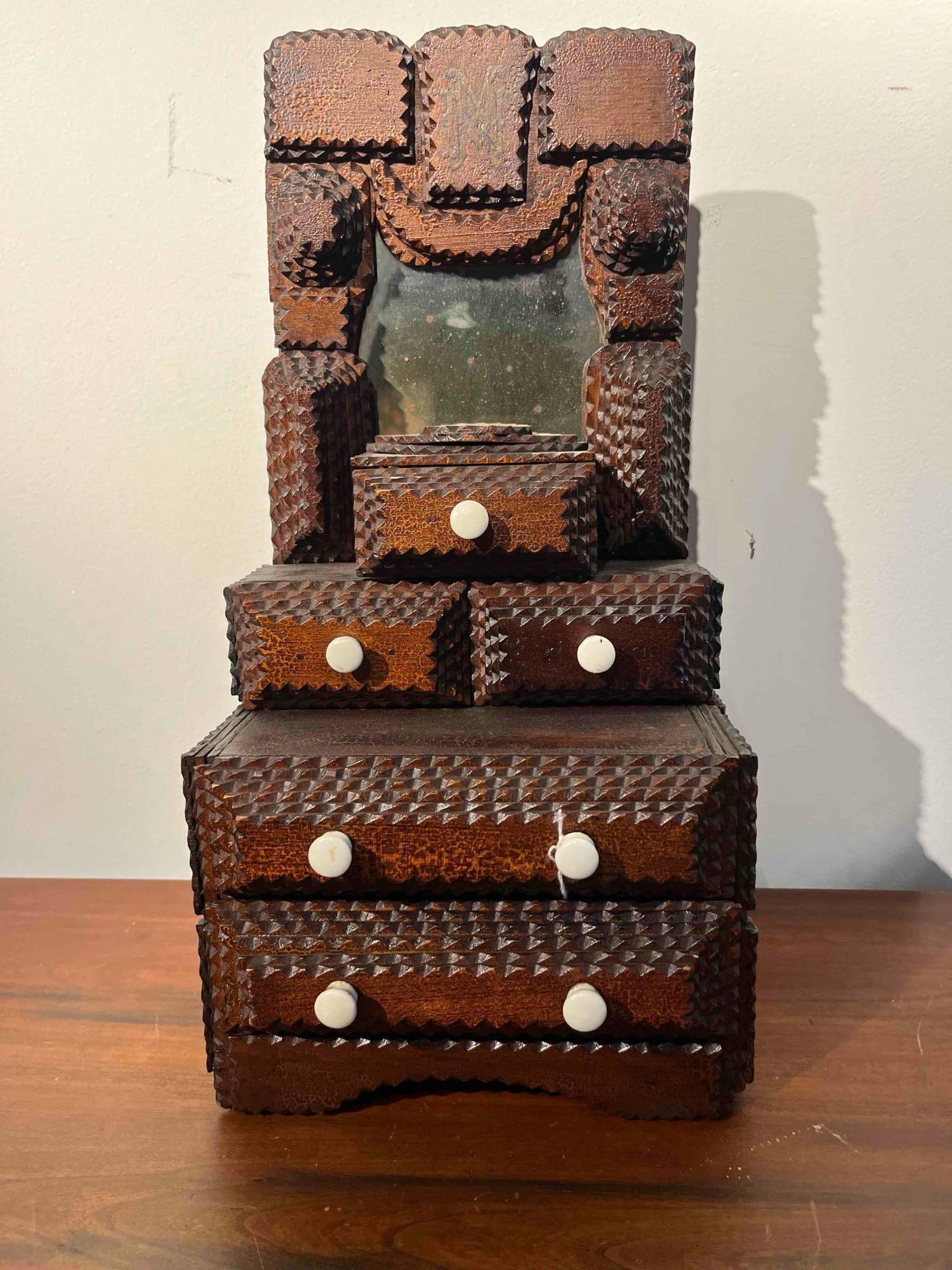 American Tramp Art Mirrored Dresser: A miniature tramp art dresser or vanity-top chest of drawers constructed from multiple layers of dark-stained chip-carved and notched wood. The piece features a vertical backboard housing a rectangula