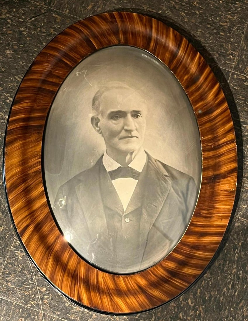 Crayon Portrait, Faux Tiger Maple Frame: An bust-length portrait of a mature gentleman, presented as a convex silver bromide enlargement with hand-finished details characteristic of a crayon portrait. The subject is depicted in late Victoria
