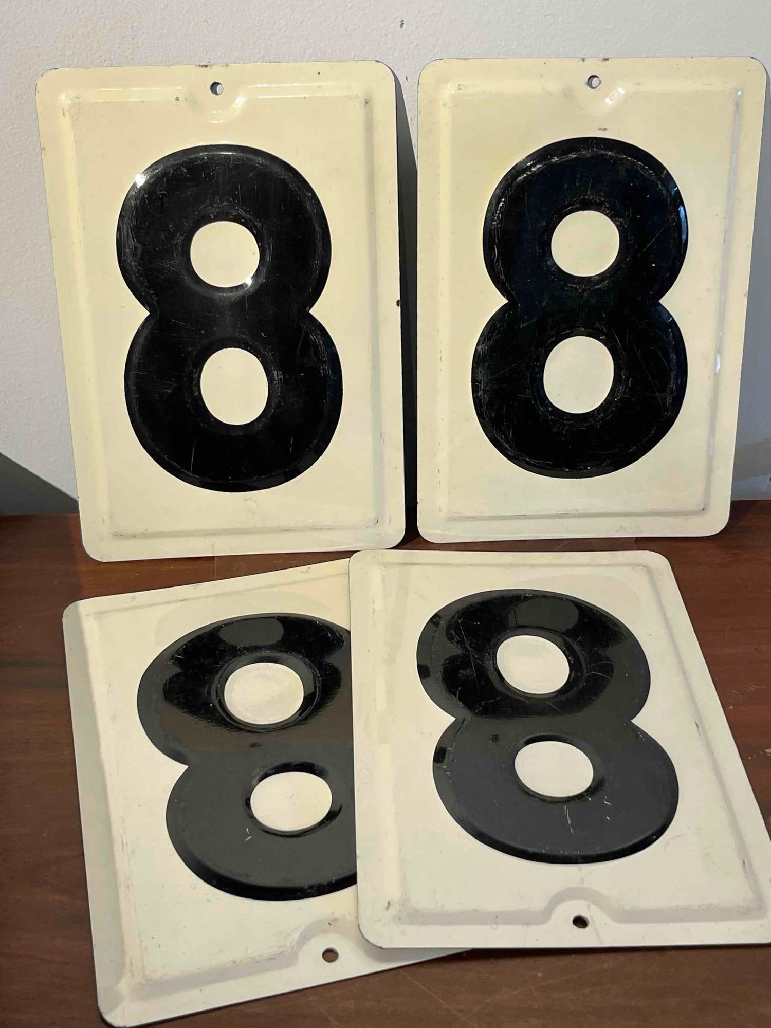 Set 4 Embossed Enamel Metal 8 Signs: This set of four matching signs is constructed from heavy-gauge embossed steel with a high-gloss enameled finish. Each rectangular plaque features a large, stylized numeral 8 in black set against a cr