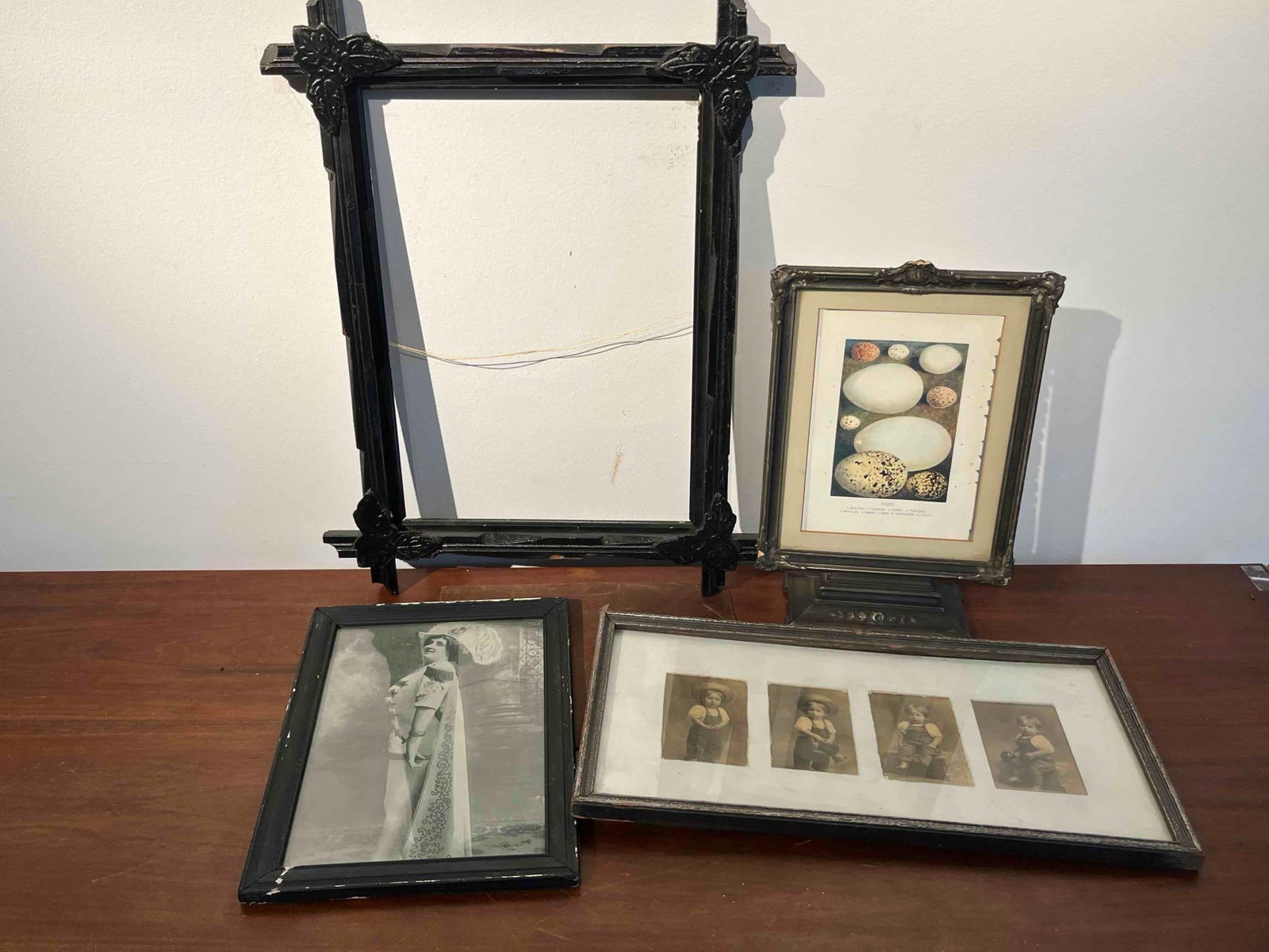 4 Frames, Photographs & Botanical Print: A group of four items consisting of various frames, photographs, and a botanical print. The collection includes a large, black-painted wooden frame designed with crossed-rail joinery and featuring car