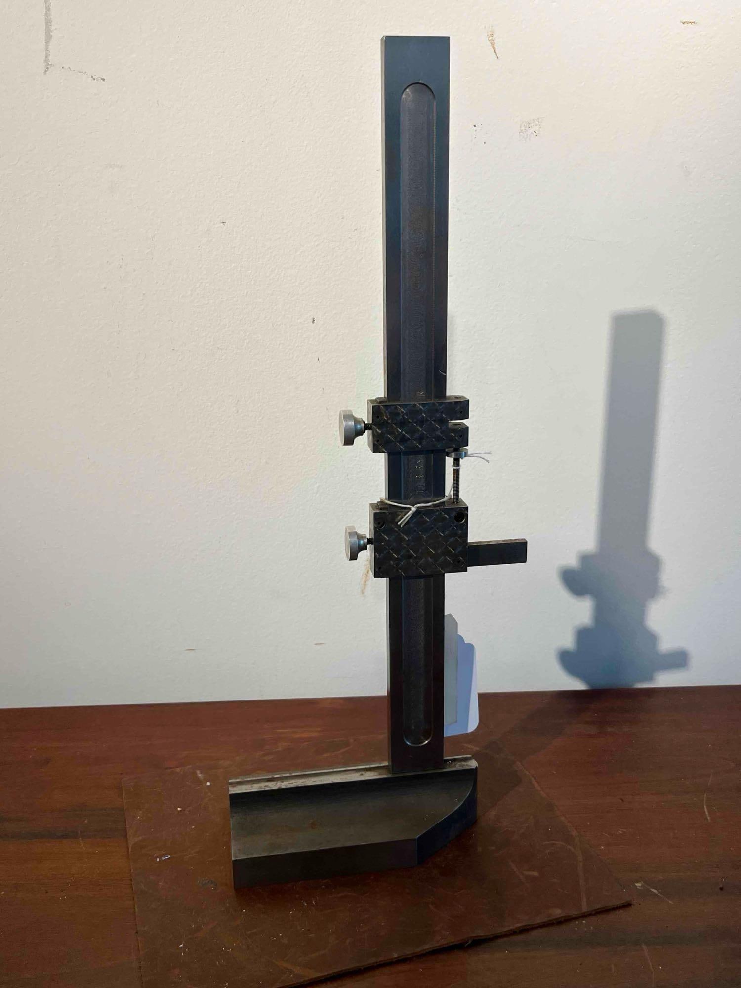 Terry Precision Transfer Height Gauge: This precision machinist transfer gauge is constructed from steel and cast metal. The instrument features a heavy, stable base with a precision-ground bottom surface and a V-groove machined into its
