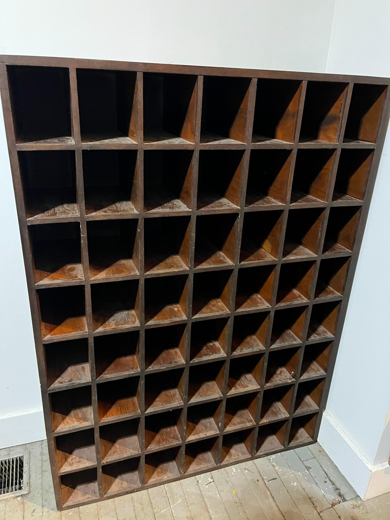 49-Compartment Wood Pigeonhole Cabinet: A utilitarian storage cabinet featuring a seven-by-seven grid of forty-nine fixed square compartments. The unit is constructed from wood with a dark reddish-brown stain, exhibiting grain patterns