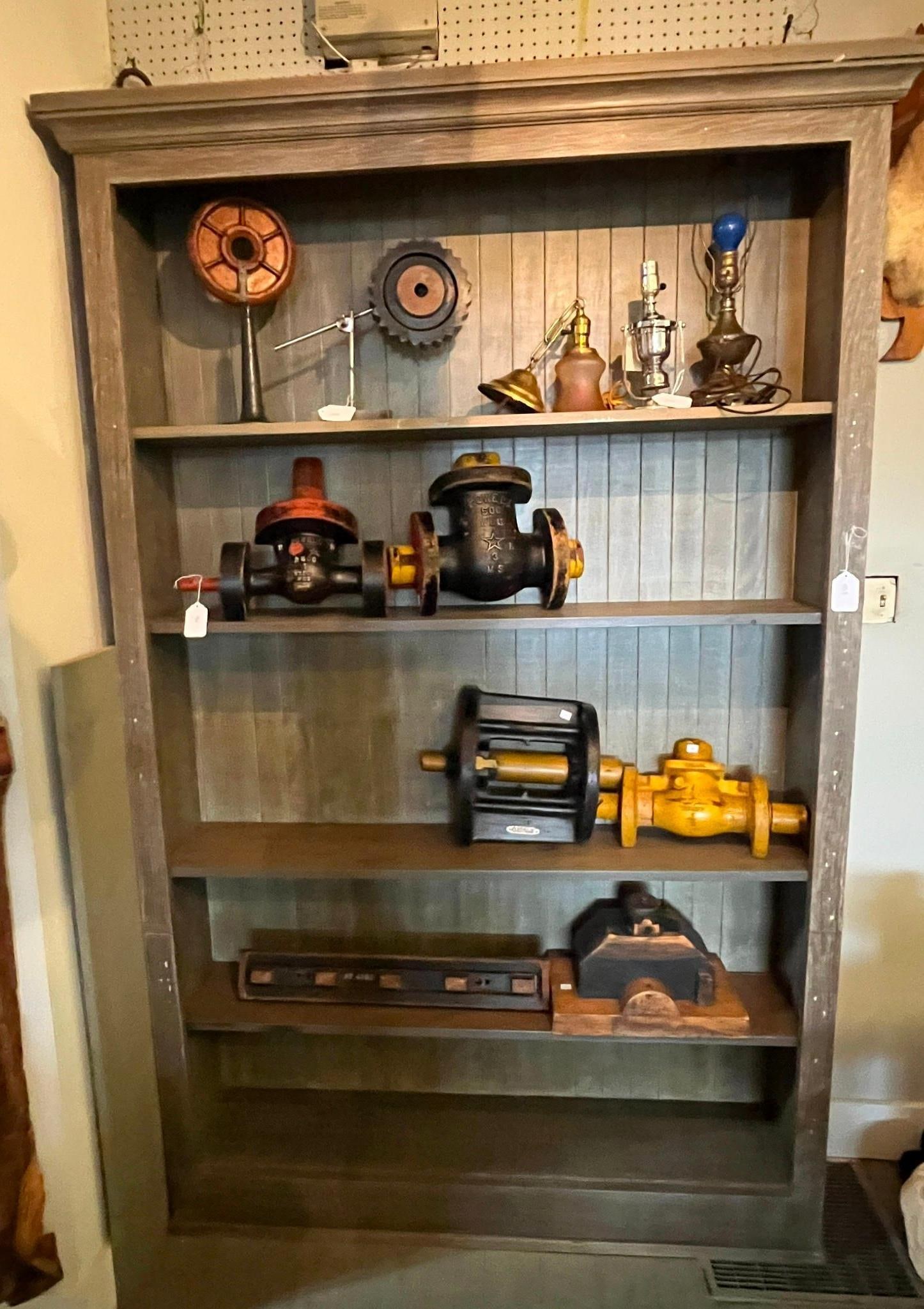 Rustic Industrial Gray Open Bookcase: This large floor-standing open bookcase is constructed of wood featuring recessed-panel sides and a vertical beadboard back panel. The unit is crowned with a substantial multi-tiered molding and