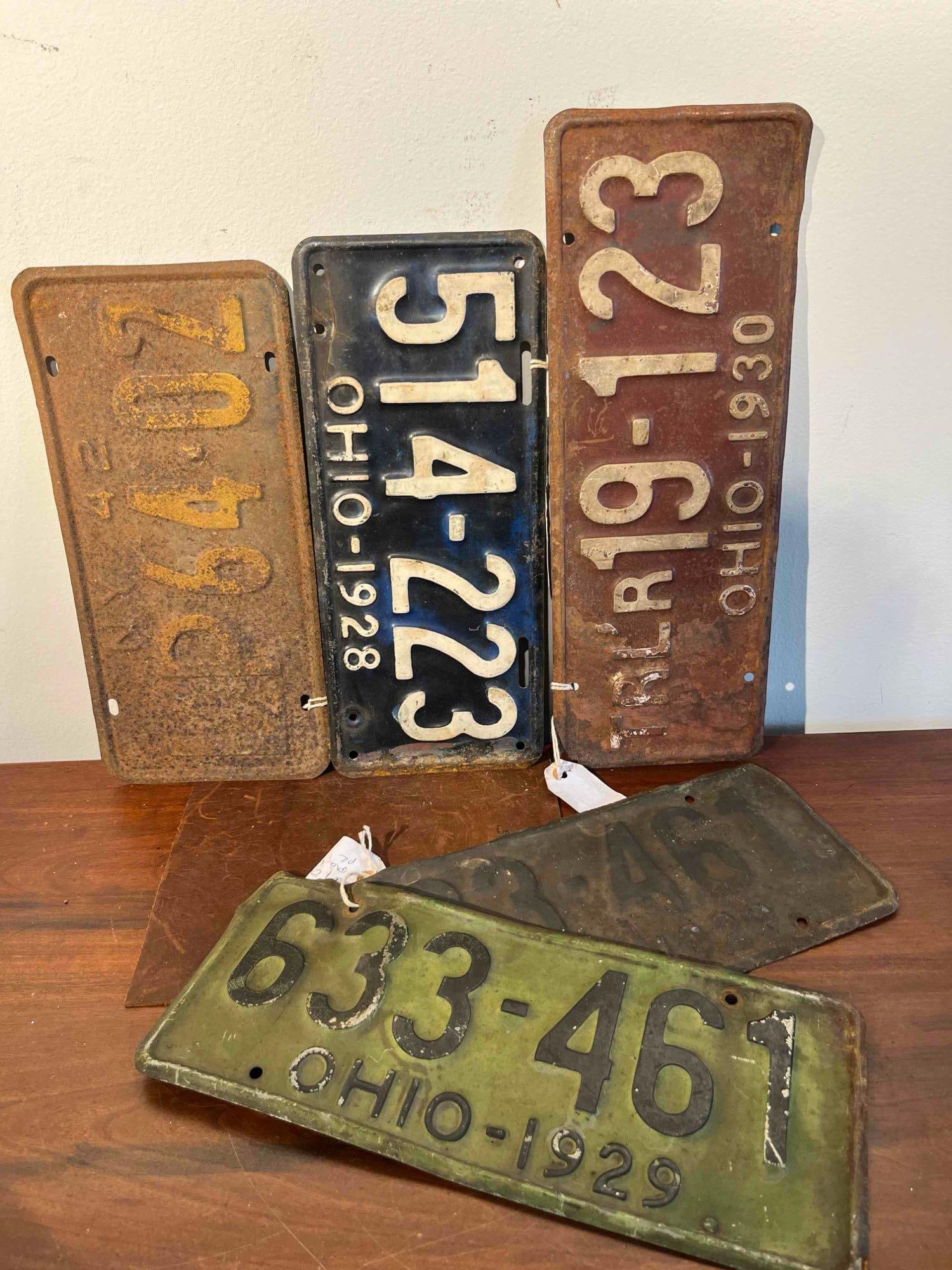 5 Ohio License Plates, 1928-1930: This group consists of five embossed steel automotive license plates issued by the state of Ohio, representing the late 1920s and early 1930s. The collection includes a matching numbered pair and a