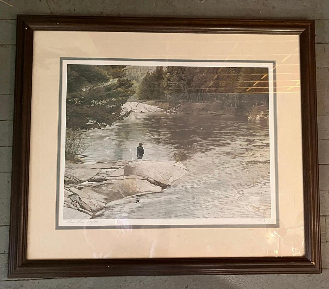 Peter Parnall, River Run, Lithograph: This limited edition offset lithograph by Peter Parnall is titled River Run. The artwork depicts a solitary fisherman standing on a light-colored rocky outcrop next to a calm river, bordered by a