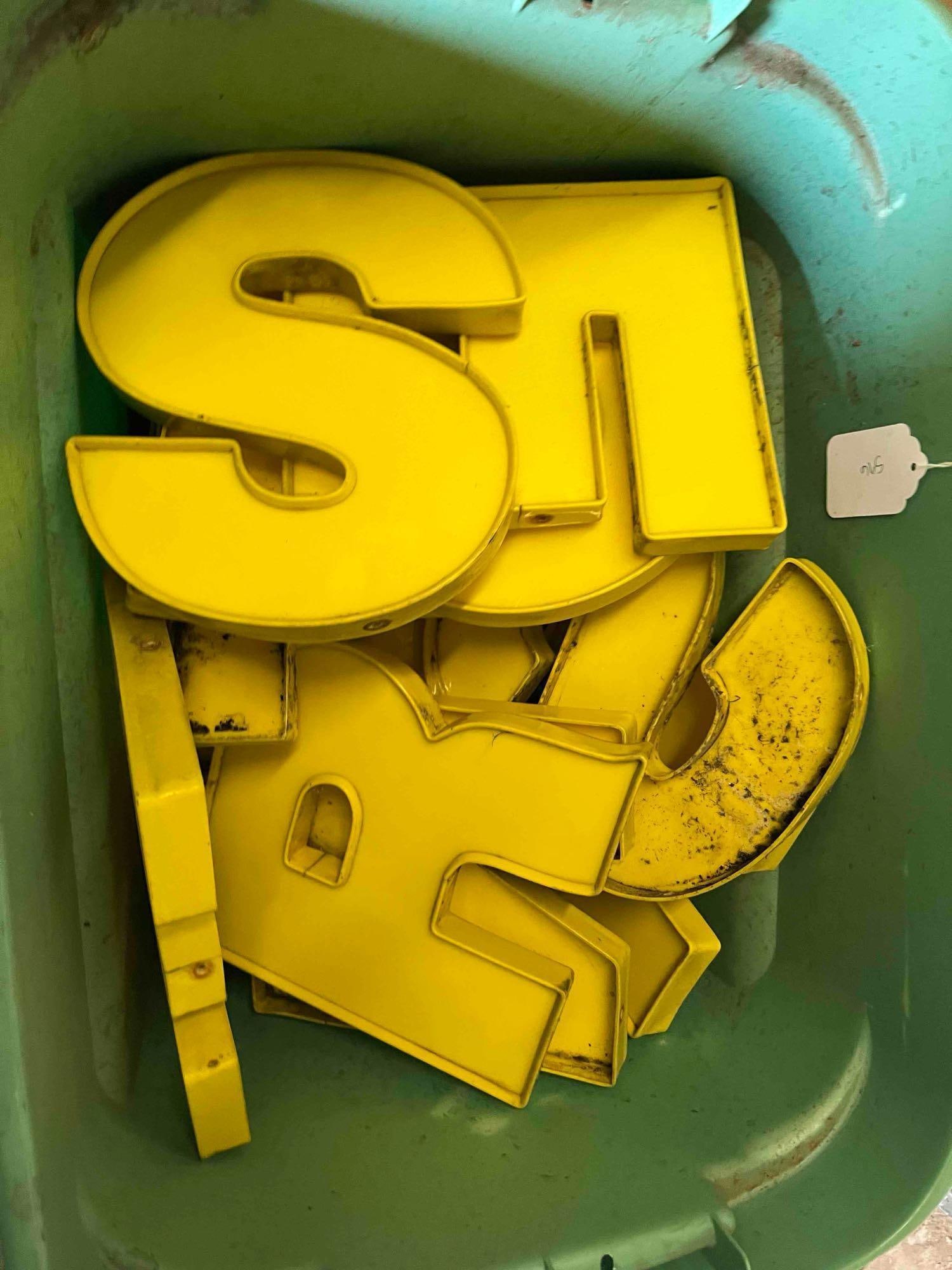 Yellow Metal Channel Sign Letters: A collection of yellow painted metal sign letters, designed in a professional channel style with raised returns approximately 2 to 3 inches deep. Constructed of painted metal, likely aluminum or