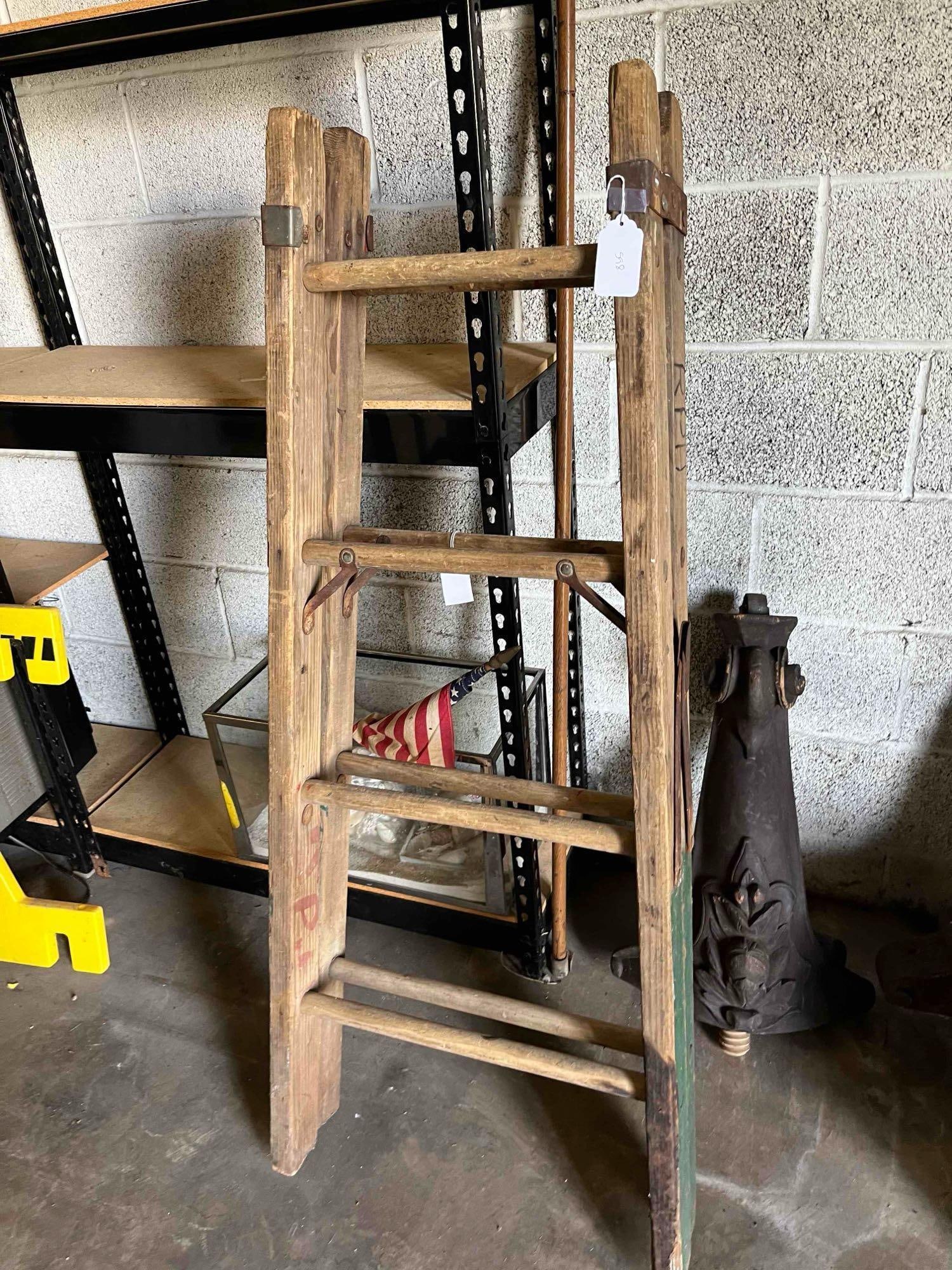 Industrial Wood Step Ladder w/ Markings: An American industrial utilitarian folding step ladder constructed from weathered hardwood with ferrous metal hardware. The ladder features round dowel rungs set into rectangular side rails. The