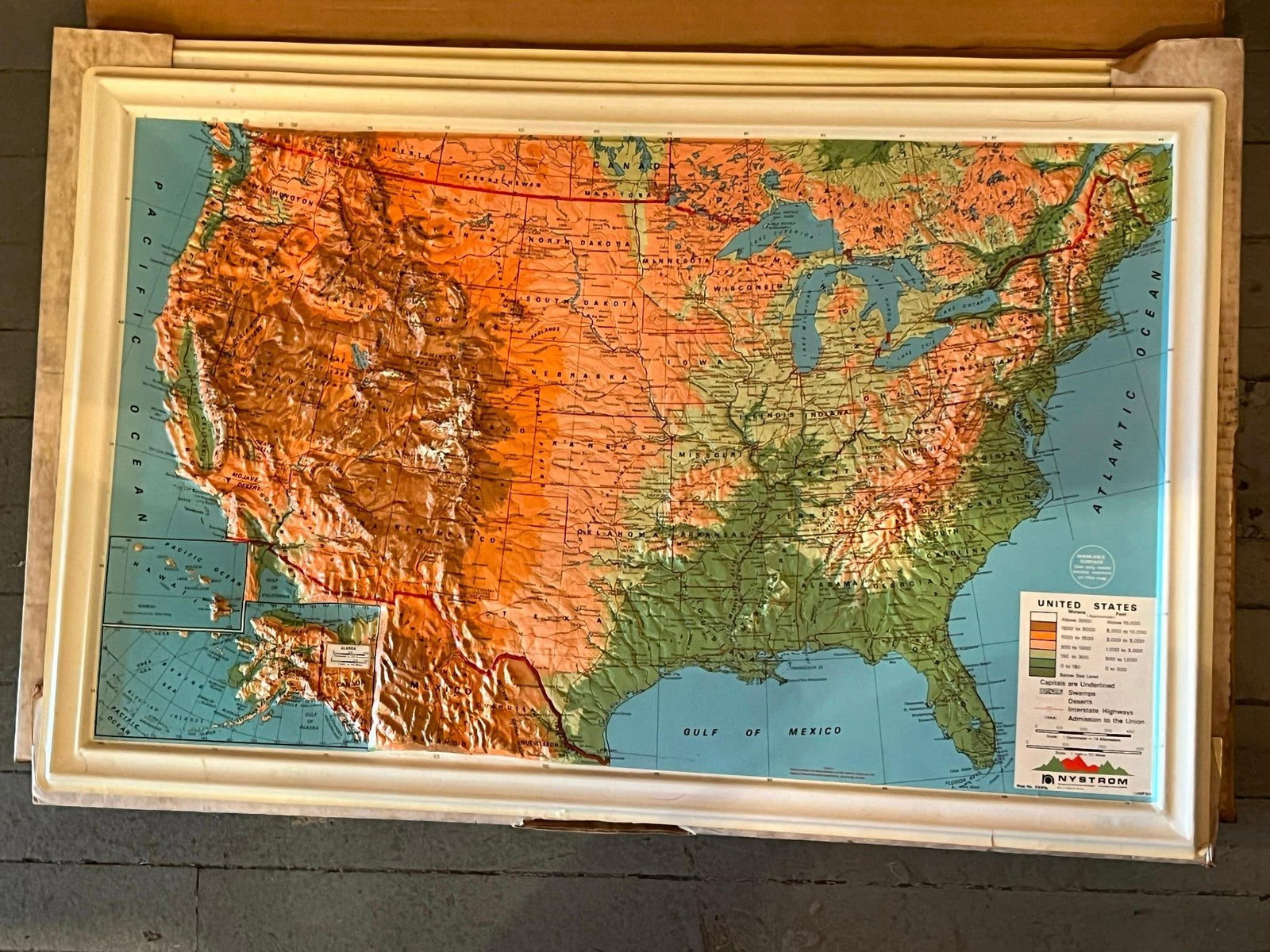 Nystrom 3D Raised Relief USA Map w/Box: A three-dimensional topographical map of the United States produced by Nystrom. The map is constructed from vacuum-formed plastic, featuring a raised-relief surface that physically represents the