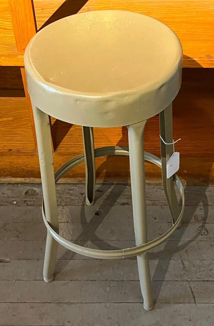 Painted Industrial Metal 3-Leg Stool: An industrial backless stool constructed of painted metal. The circular seat is formed from pressed metal with a deep apron and is supported by three tapered legs of folded metal construction. A