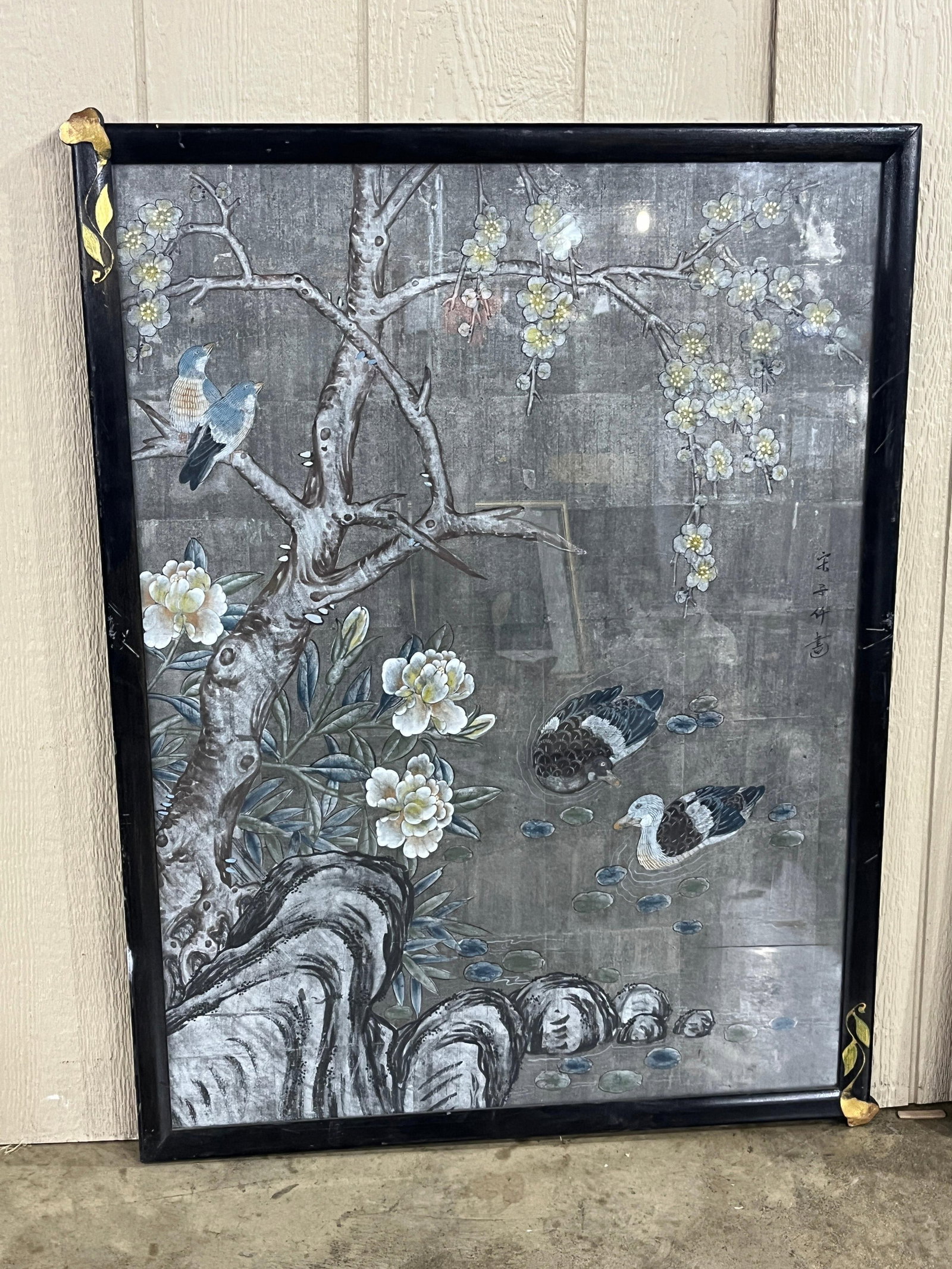 Song Zihui Chinese Applique Birds Panel: This framed Chinese wall panel is executed in the bird and flower style and features low-relief applique elements on a grey metallic-toned ground. The scene depicts a blossoming tree, two birds with