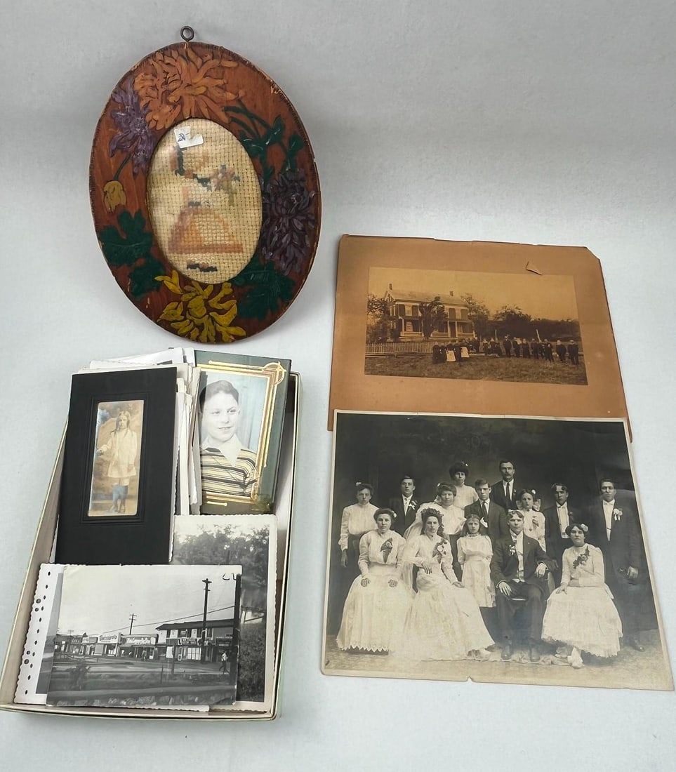 Photographs & Framed Needlework: A collection of silver gelatin prints and personal snapshots dating from the early to mid-20th century, accompanied by an oval wooden framed needlework. The photographic subjects include a large