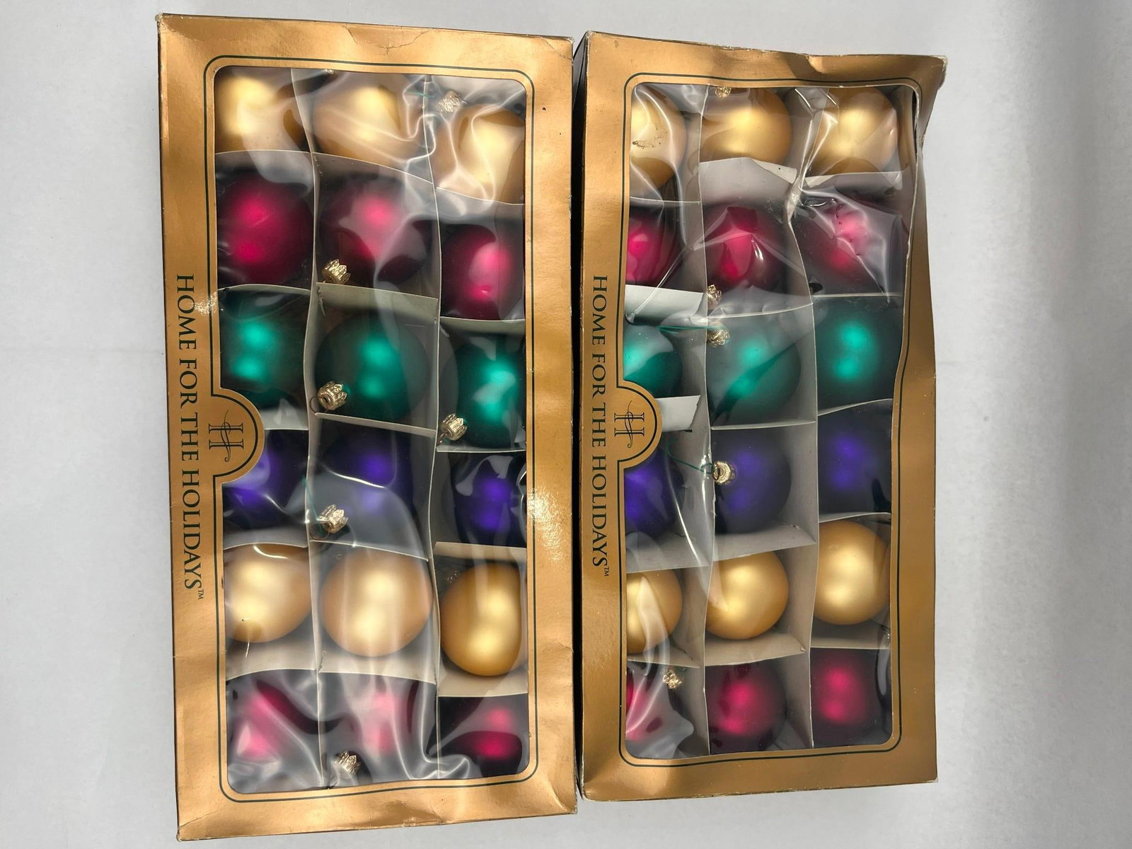 36 Home Holidays Euro Glass Ornaments: A collection of thirty-six handblown glass ball ornaments produced for the Home for the Holidays brand. The ornaments feature a matte or satin finish in a palette of four colors: gold, magenta, teal, 