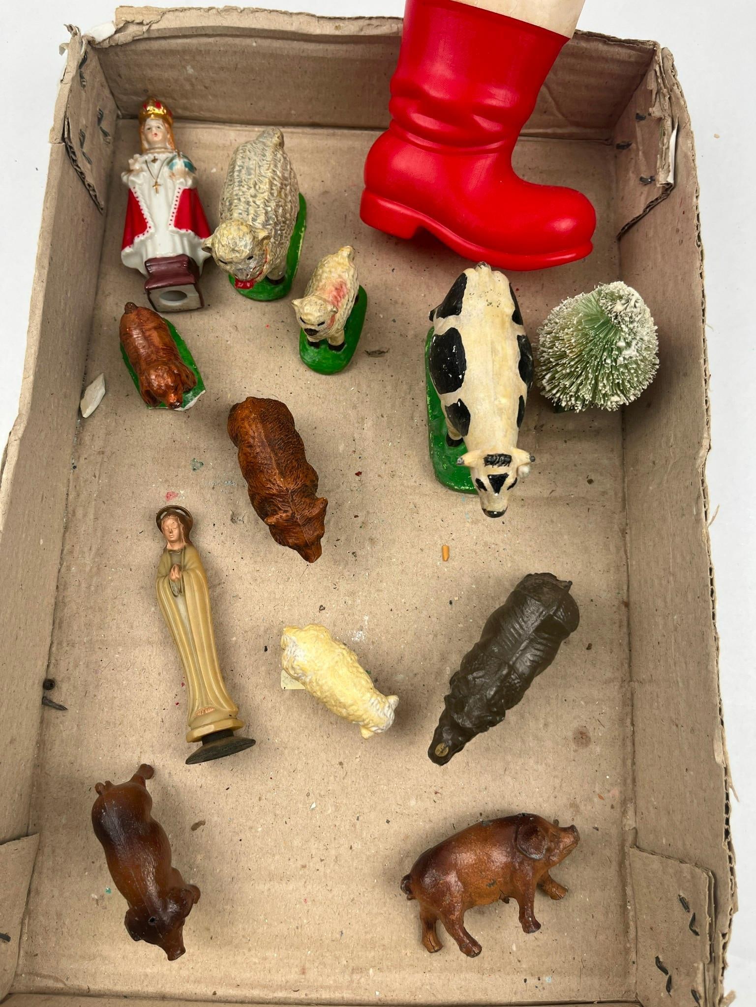Somoplast Rhino & Religious Figurines: An assortment of toy figurines and decorative items featuring a variety of materials and subjects. The lot includes a French dark brown molded plastic rhinoceros figurine with an embossed mark on the