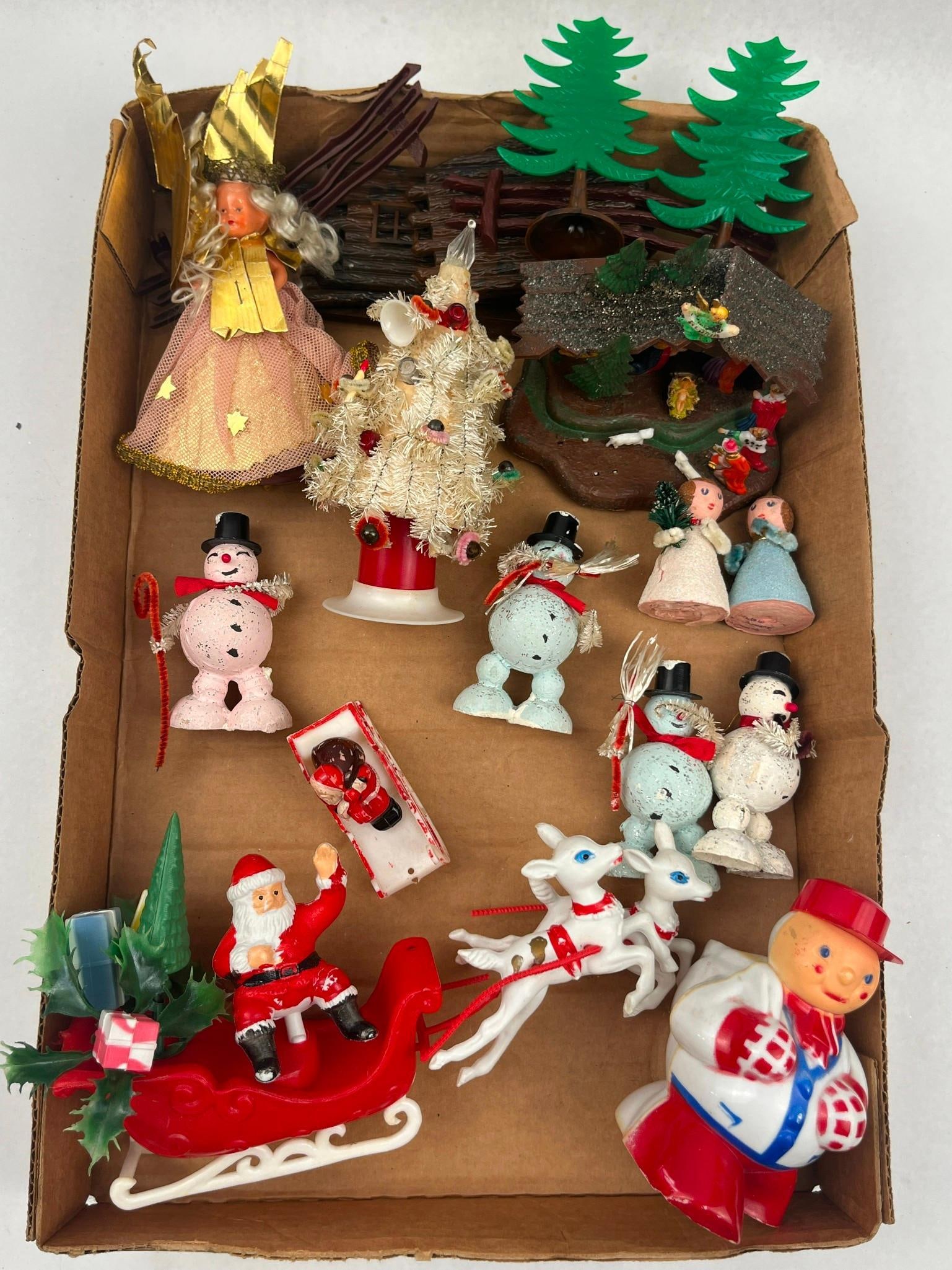 Mid-Century Christmas & Figurines: A group of Christmas decorations and figurines dating to the mid-20th century, primarily constructed from hard plastic, celluloid-style materials, and bottle-brush tinsel. The lot includes a large