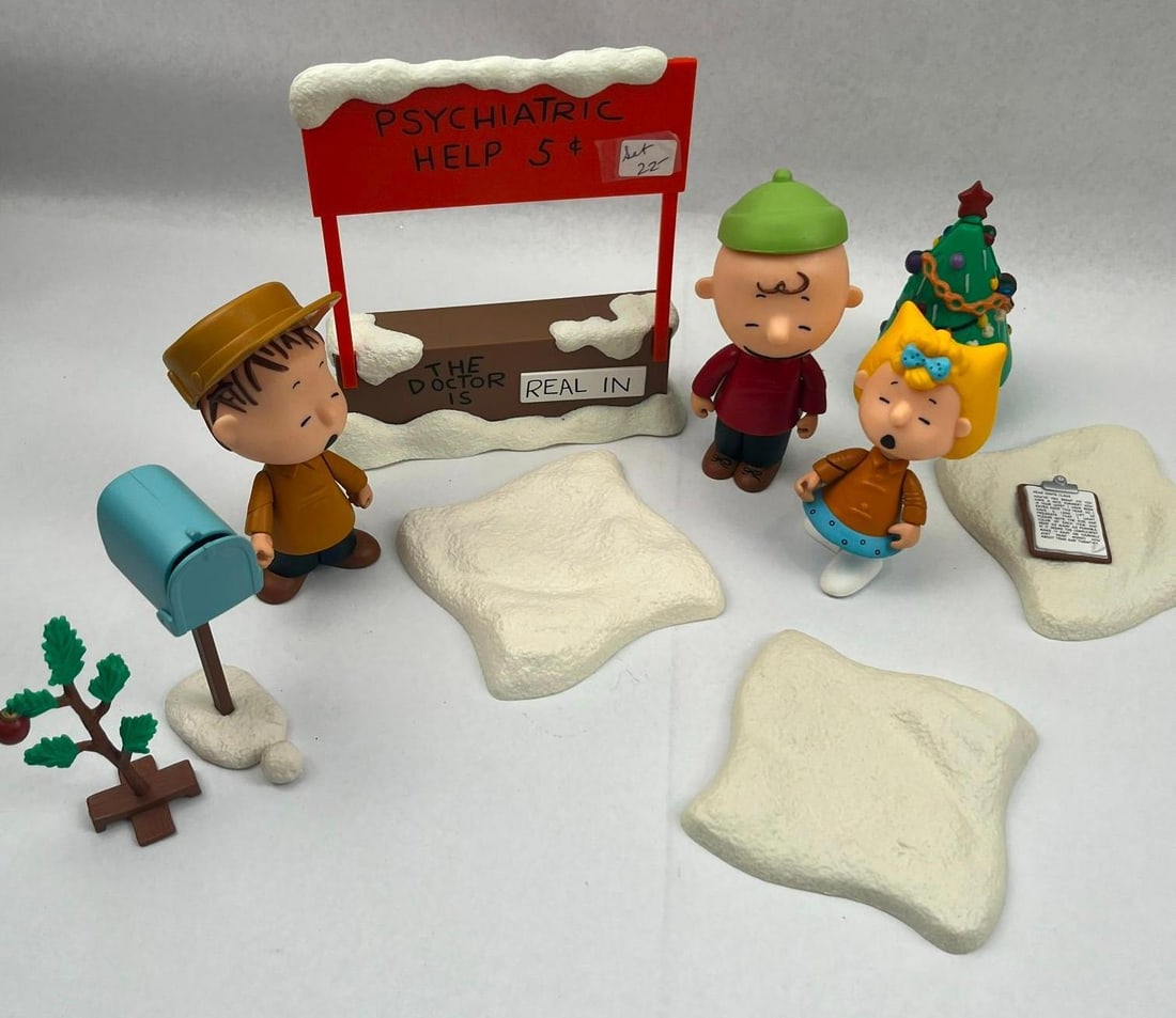 Peanuts Charlie Brown Xmas Figs & Acc: A set of molded plastic figures and diorama accessories based on the animated special, A Charlie Brown Christmas. The collection features figures of Charlie Brown in a red shirt and green hat, Linus