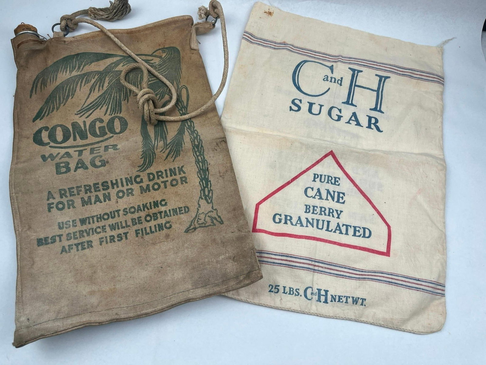 1934 C&H Sugar Sack & Congo Water Bag: This lot features two mid-20th-century advertising textile bags of different utility. The first is a self-cooling water bag manufactured from heavy tan canvas, designed for automotive travel or campin