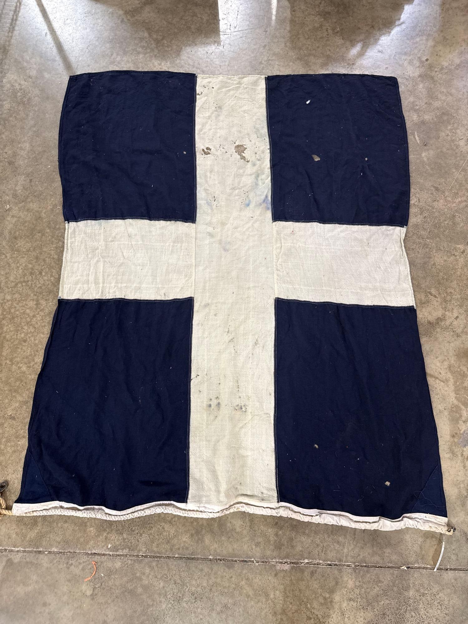 Jones Pioneer Canadian Signal Flag M: This maritime signal flag represents the letter M (Mike) in the International Code of Signals, signifying a vessel is stopped and making no way through the water. The design features a white Greek cro