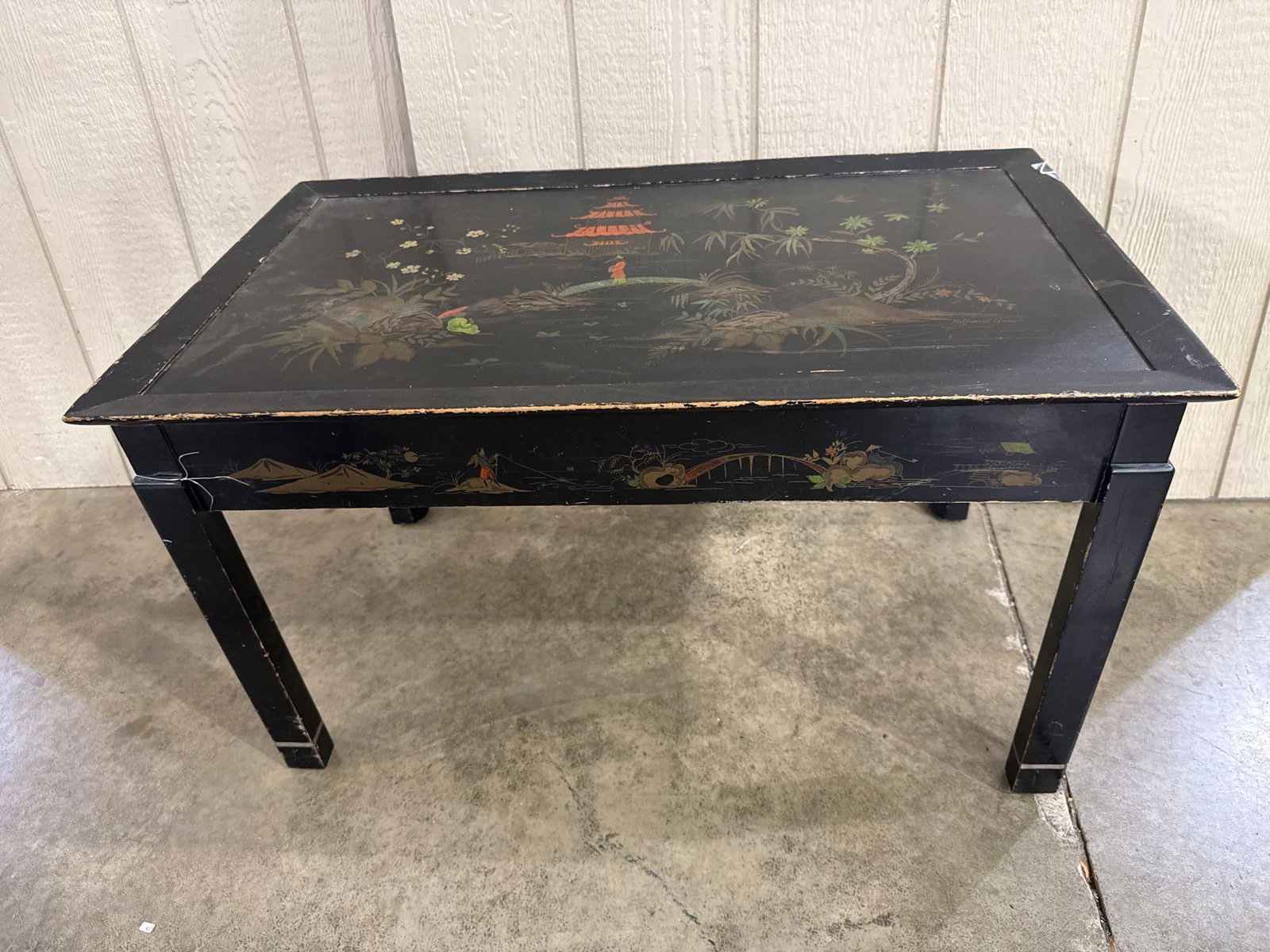 Katherine Henick Chinoiserie Table: A mid-20th century black lacquered coffee table featuring hand-painted Chinoiserie decoration. The rectangular piece is constructed with a recessed top panel surrounded by a raised molded perimeter. T