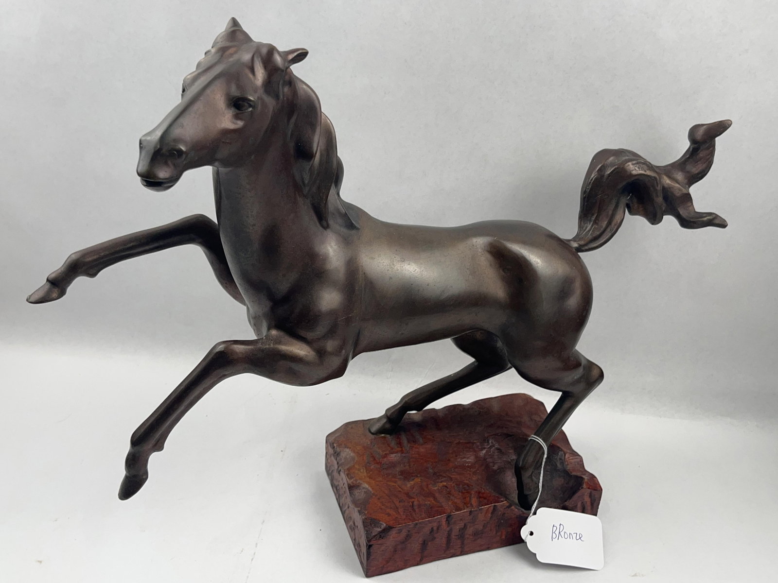 Bronze Rearing Horse Sculpture w/ Base: This large-scale cast bronze sculpture captures a horse in a powerful leaping motion, executed in a modernist style with simplified, fluid anatomical planes. The work features a distinctive