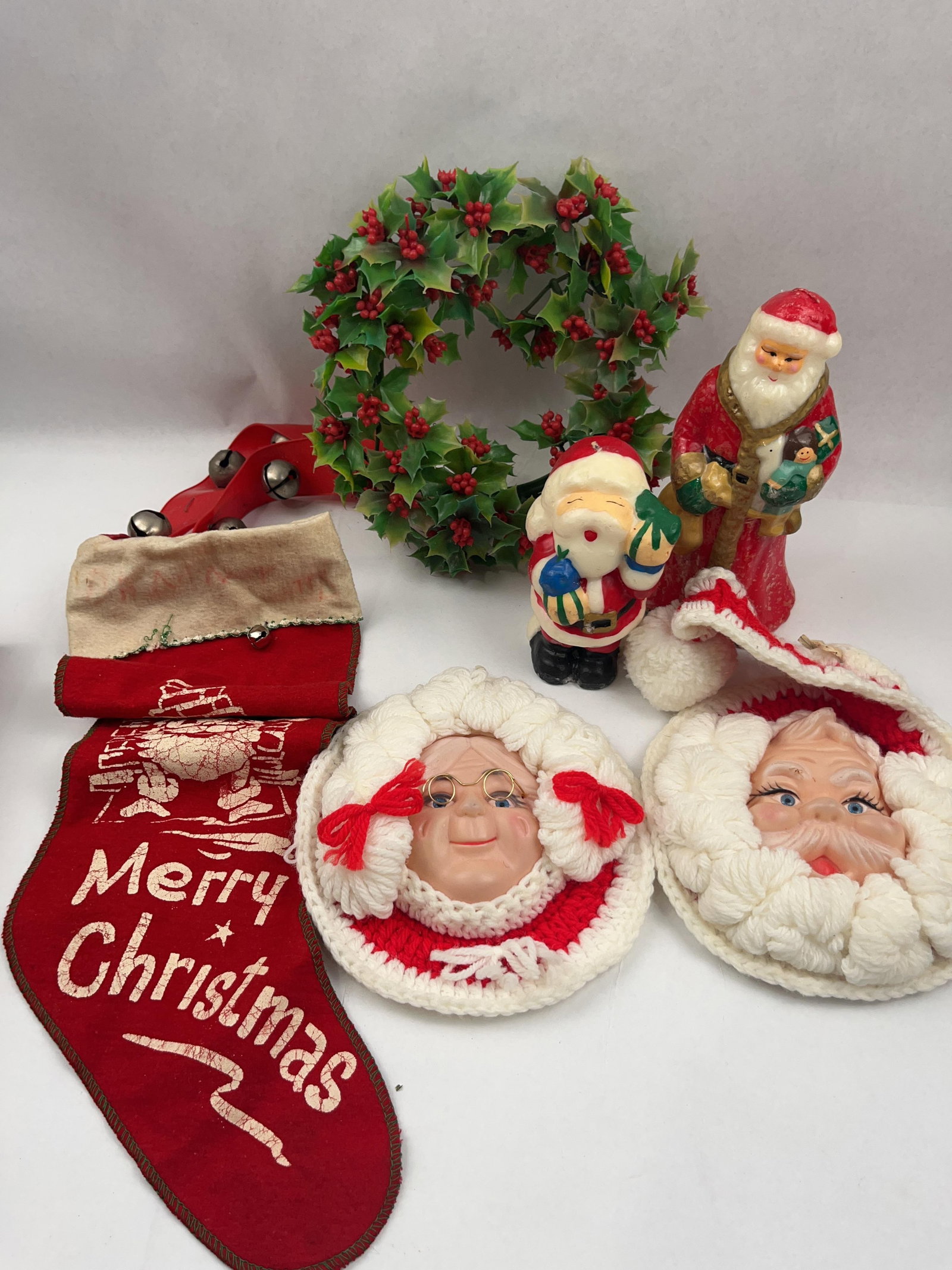 Vtg Christmas Decor & Collectibles: A collection of vintage holiday decorations including a red felt stocking, wall ornaments, a wreath, and wax candles. The red felt stocking features a screen-printed white illustration of Santa Claus