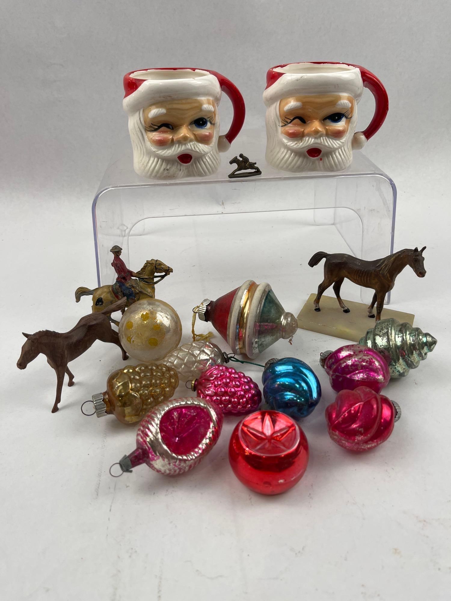 Japanese Santa Mugs, Glass & Horses: A collection of seventeen vintage decorative items comprising ceramic, glass, metal, and plastic components. The lot includes two glazed ceramic mugs shaped as winking Santa Claus heads, with the red
