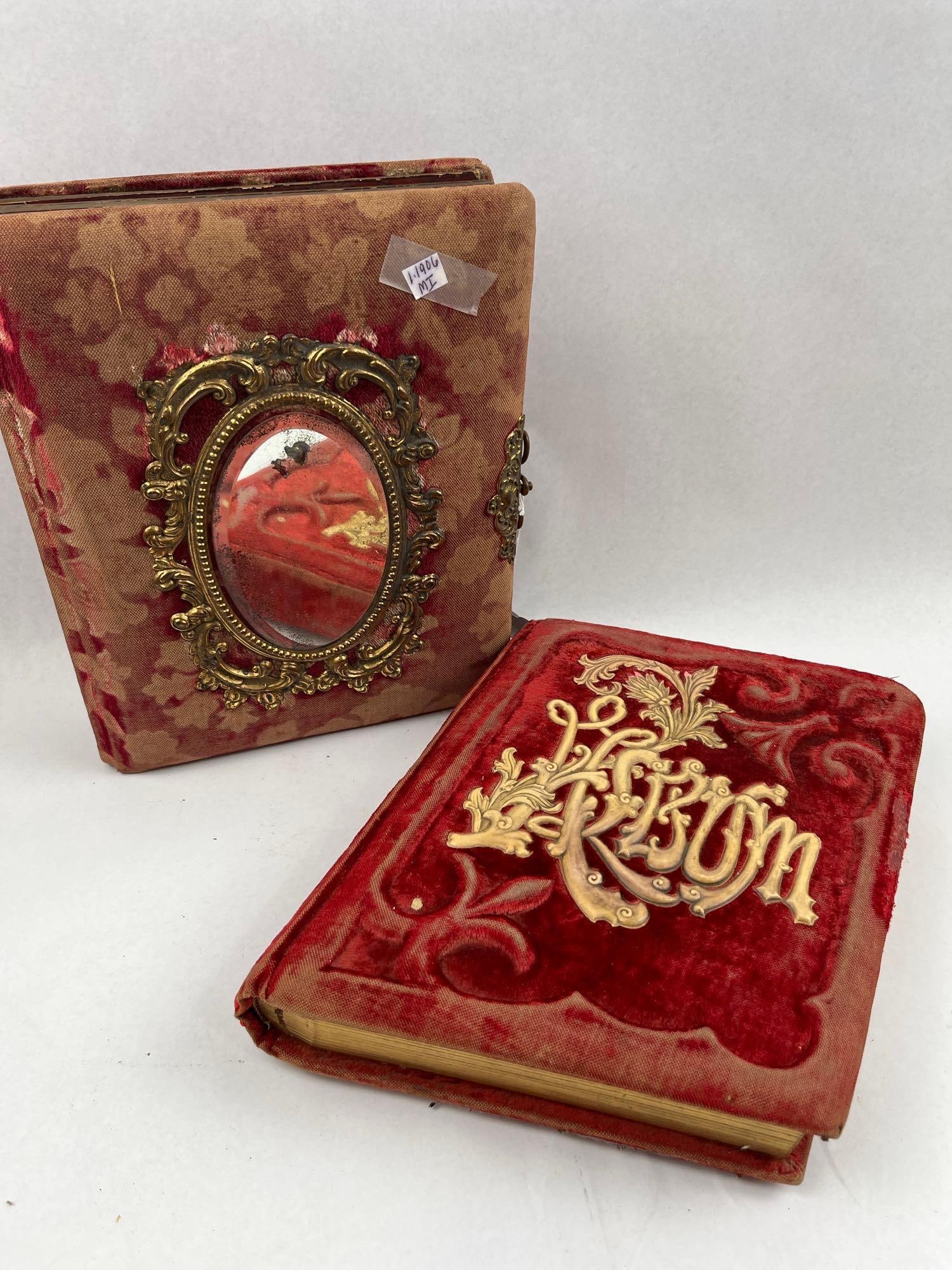 Pair Victorian Red Velvet Photo Albums: Two Victorian-era cabinet card photo albums. The front cover features an ornate gilt-metal frame in the Rococo style, inset with an oval mirror. The larger album is bound in red velvet with an