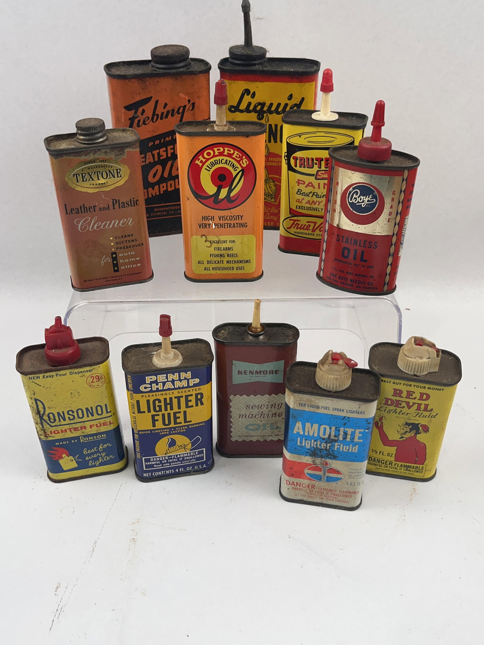 Set 11 Vtg Tin Oil & Lighter Fluid Cans: A group of eleven mid-20th-century lithographed tin containers for various household oils, lubricants, and lighter fluids. The collection includes diverse brands and graphic styles common to the era.