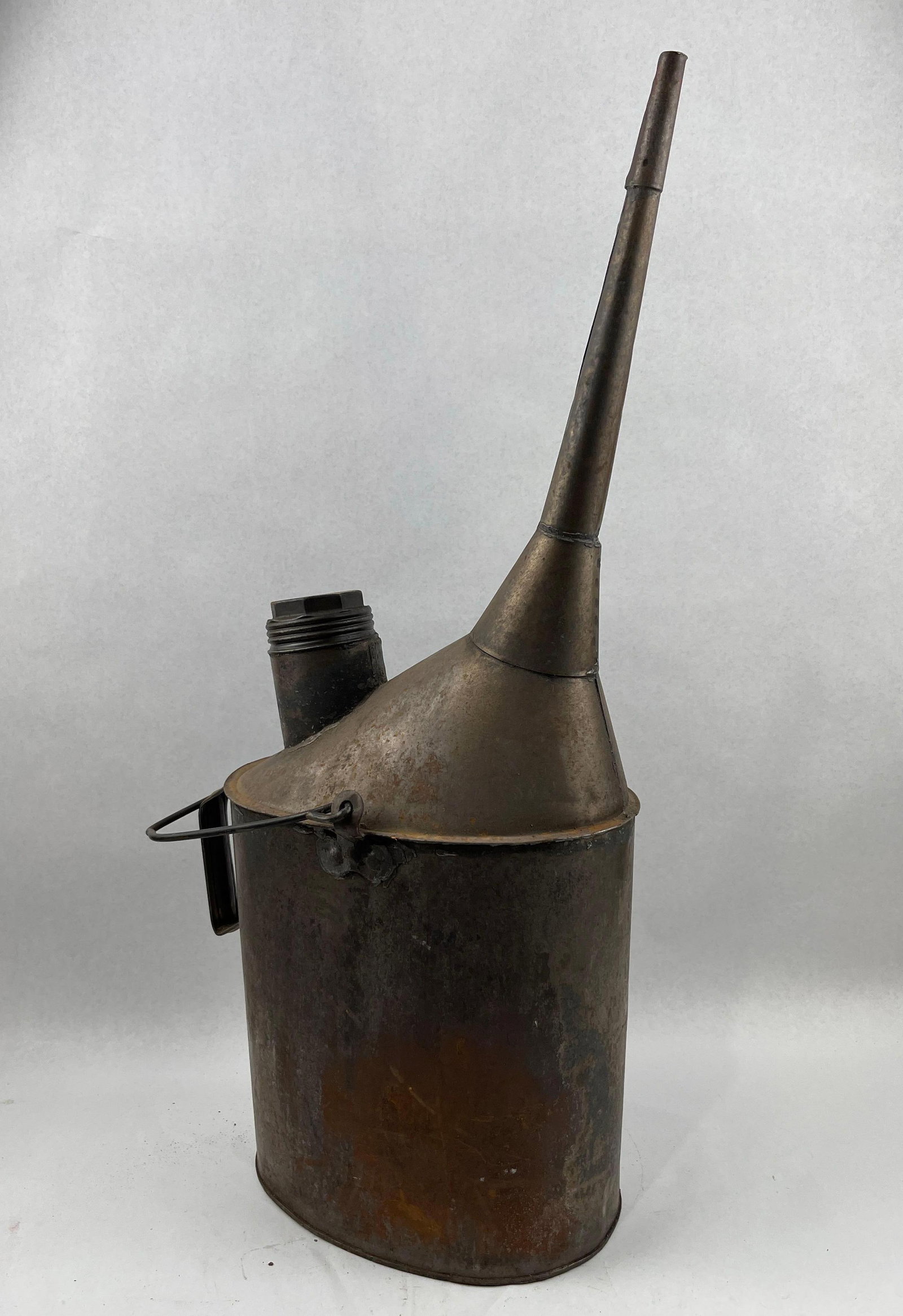 Railroad Engineers Long Spout Oil Can: This antique industrial filler can is an example of a railroad engineers' oiler, characterized by its long, tapered offset spout. The vessel is constructed from galvanized steel with rolled seams and 