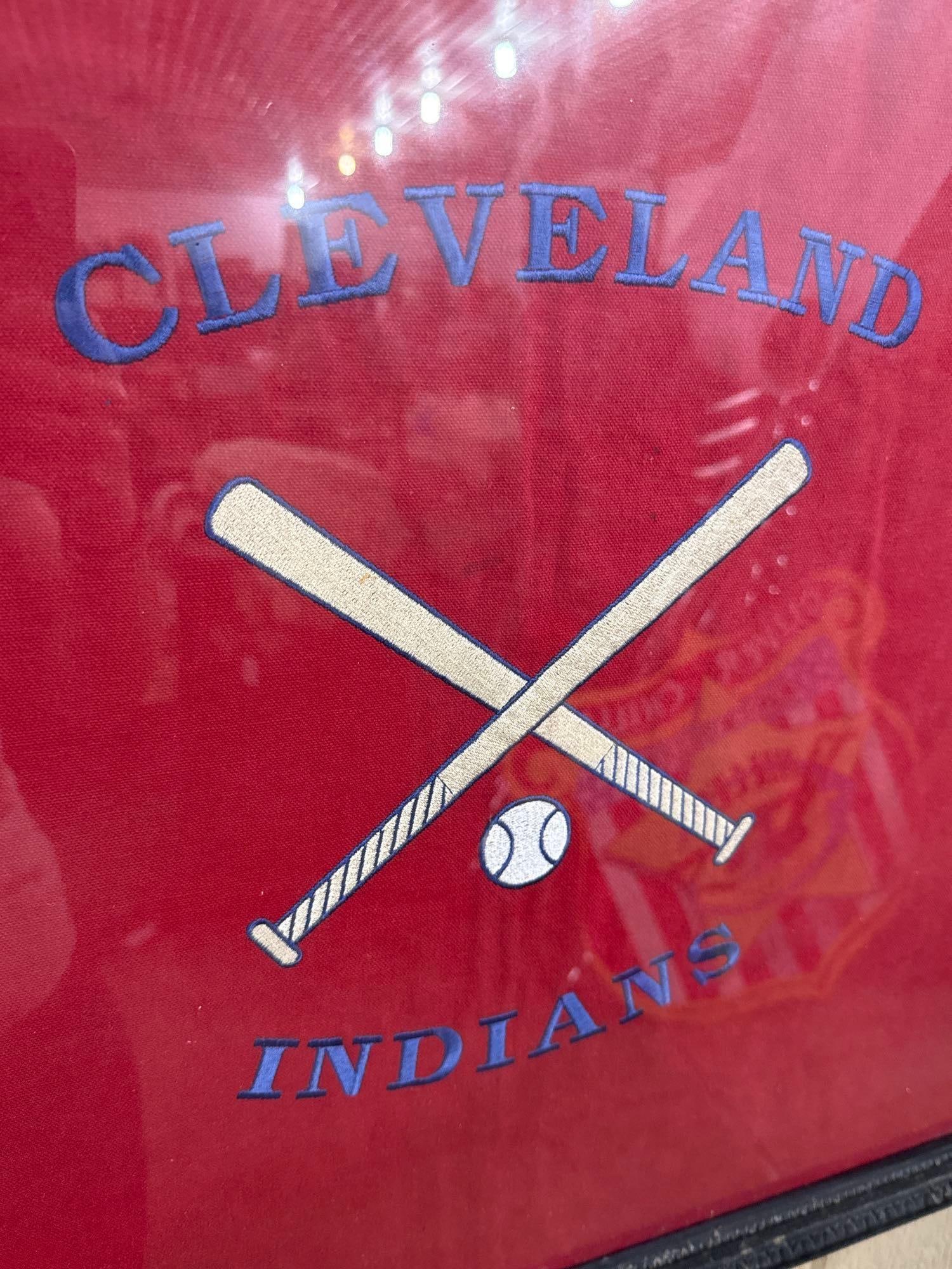 Cleveland Indians Baseball Embroidery: This framed textile features embroidered graphics and text representing the Cleveland Indians baseball team. The piece is constructed on a vibrant red woven fabric backing. No maker marks, labels, or