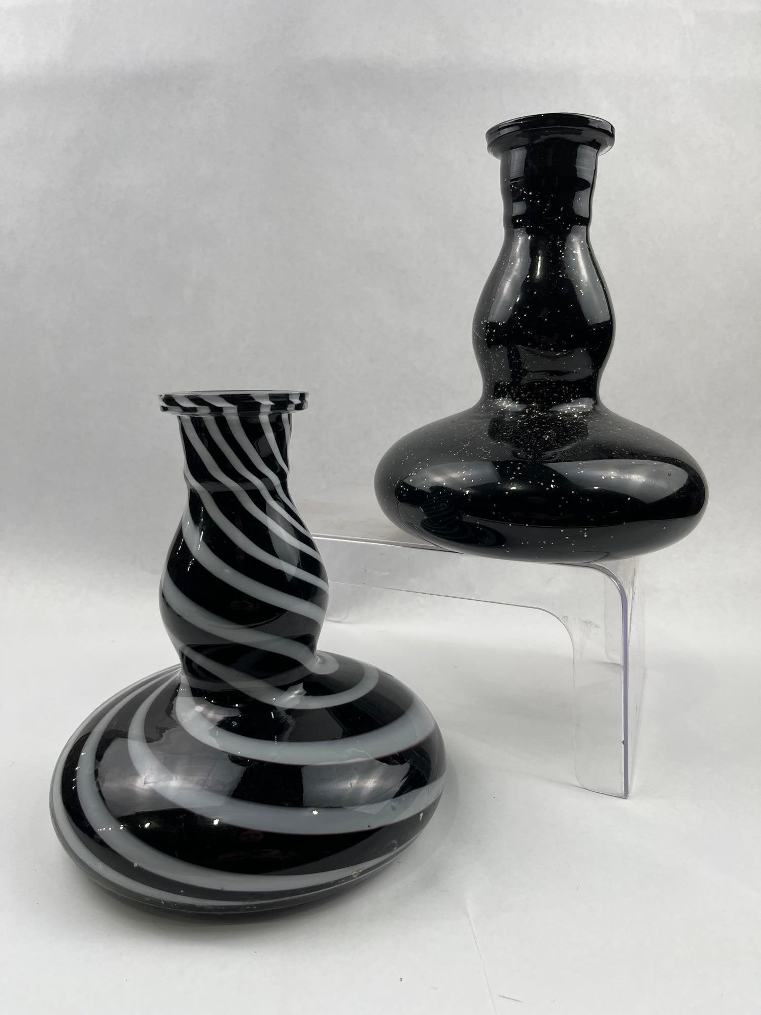 Pair Black & White Glass Hookah Bases: A pair of hand-blown glass vessels, each featuring a wide, bulbous gourd-like body with a tapered, double-shouldered neck and a wide, flared rim. The first vessel is composed of deep black glass