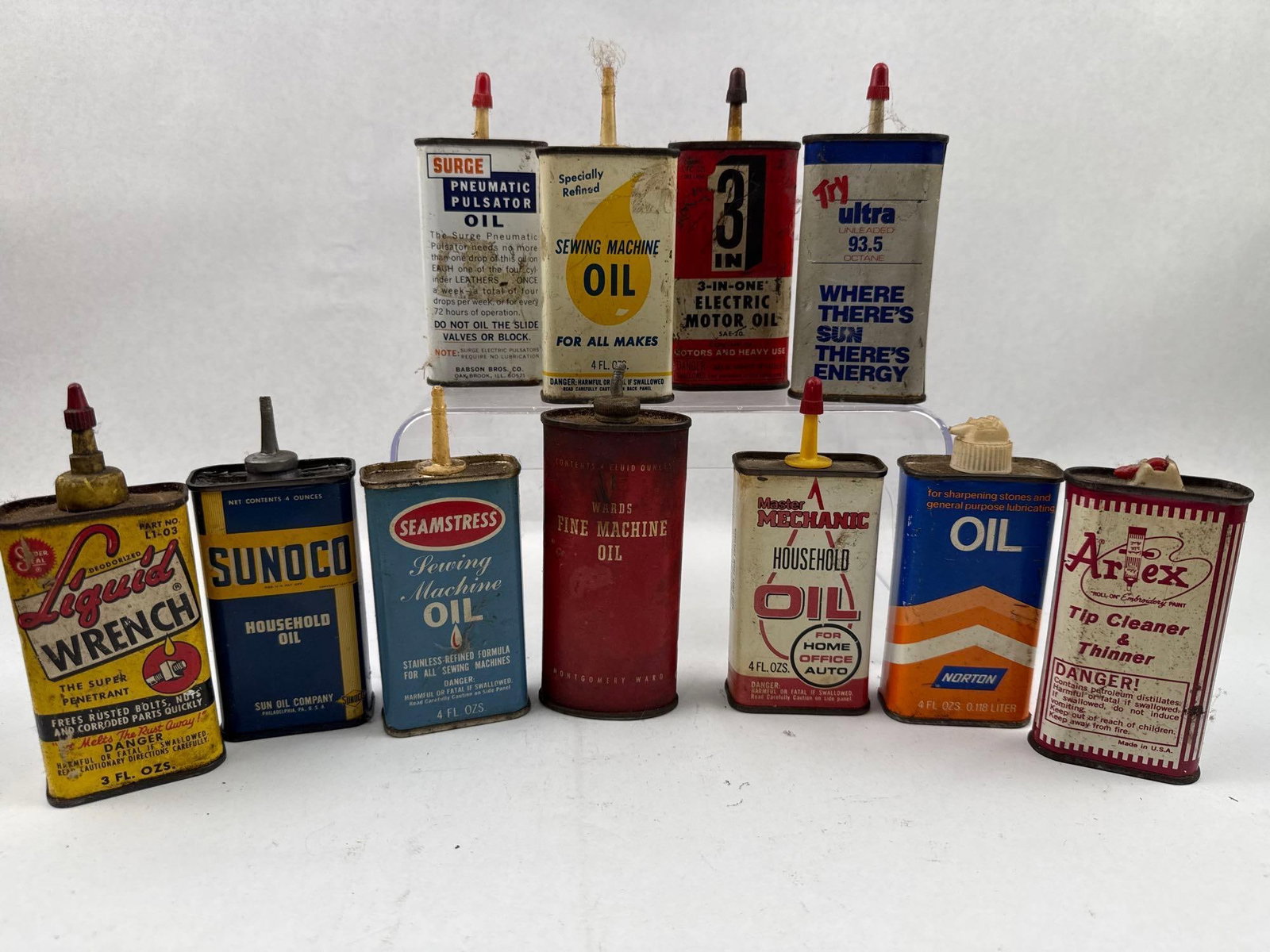 Set 12 Vtg Sunoco & 3-In-One Oil Tins: This is a collection of twelve vintage lithographed tin containers for various household and automotive lubricants and solvents. The group includes specialized products such as Liquid Wrench Super