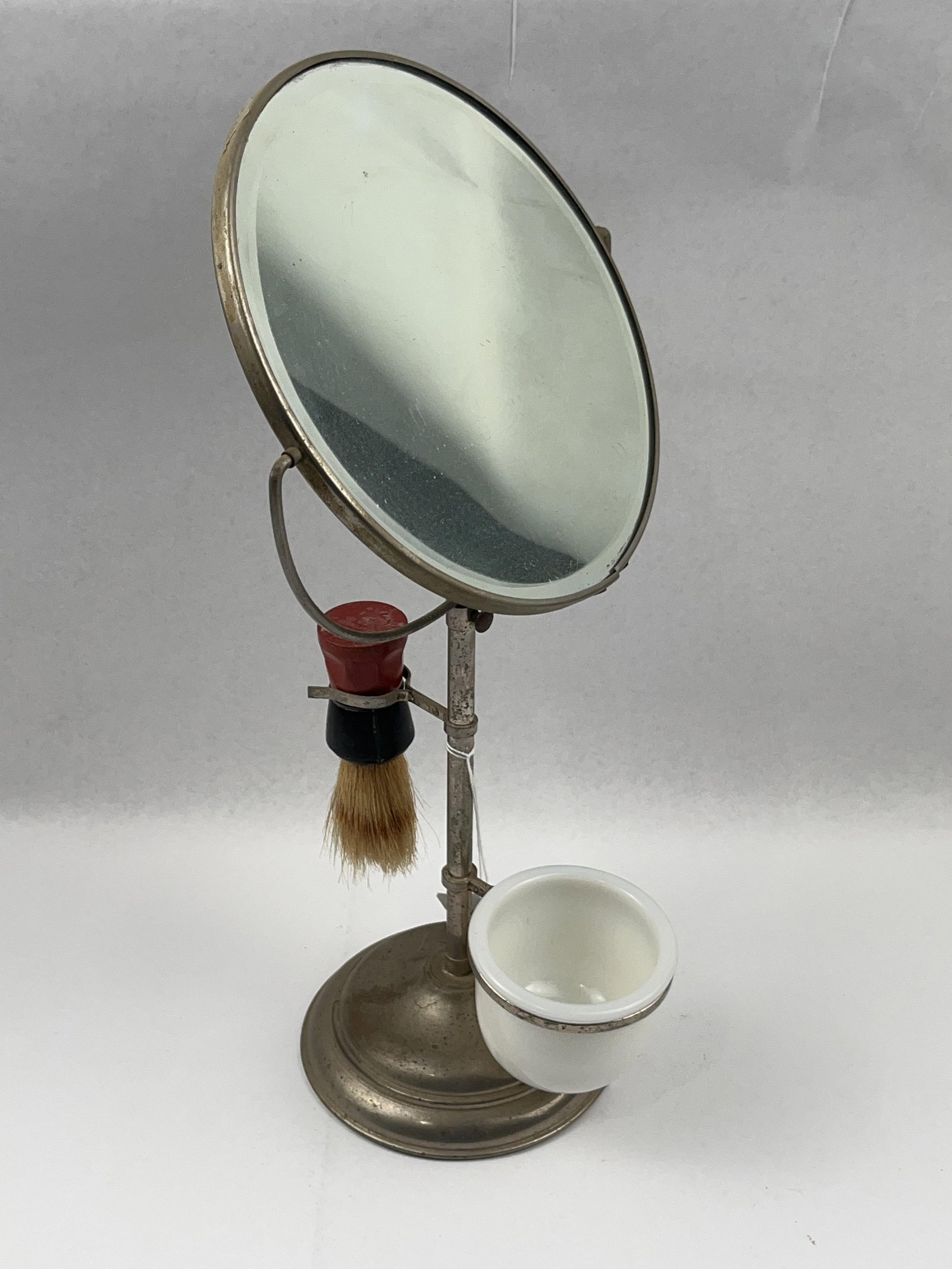 American Plated Metal Shaving Stand Set: A U.S.-made adjustable tabletop shaving stand constructed from plated metal over a weighted cast base. The stand features a central upright post supporting a double-sided circular swivel mirror