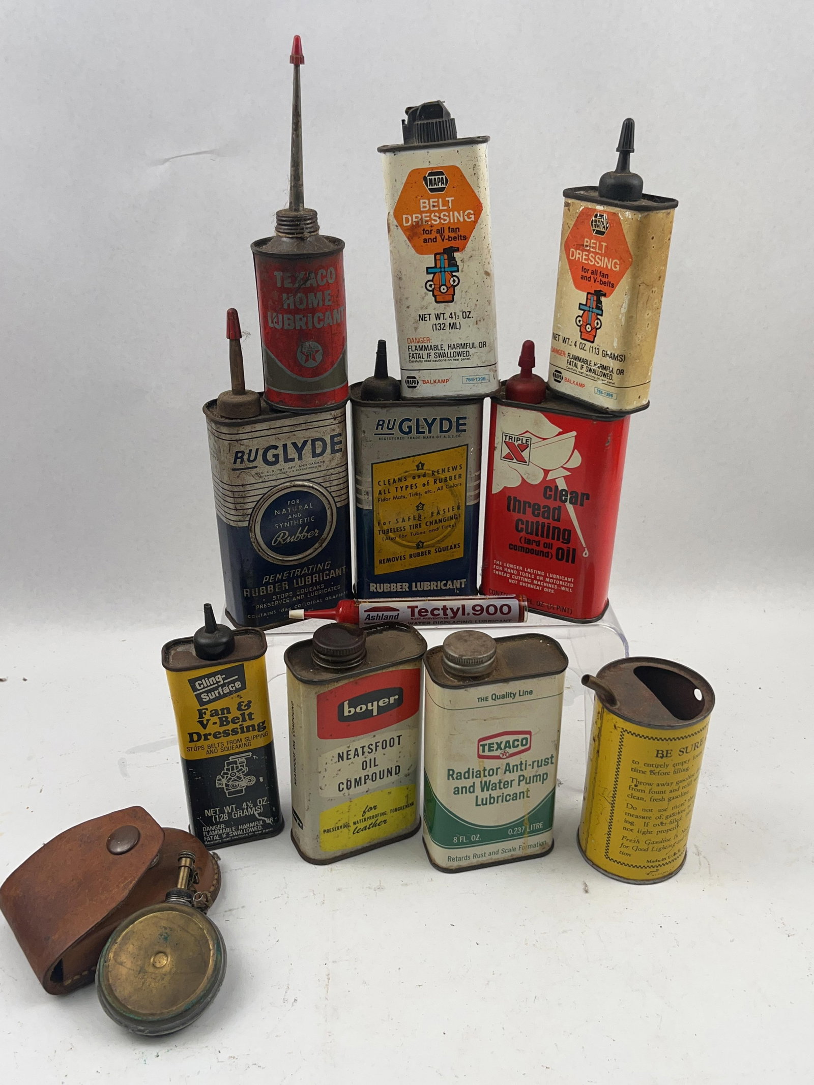 12 Vtg Auto/Home Lubricant Tins & Tools: An assortment of 12 mid-century automotive and household lubricant containers and specialty tools. The collection includes various lithographed tin cans, a plastic tube, a measuring vessel, and a